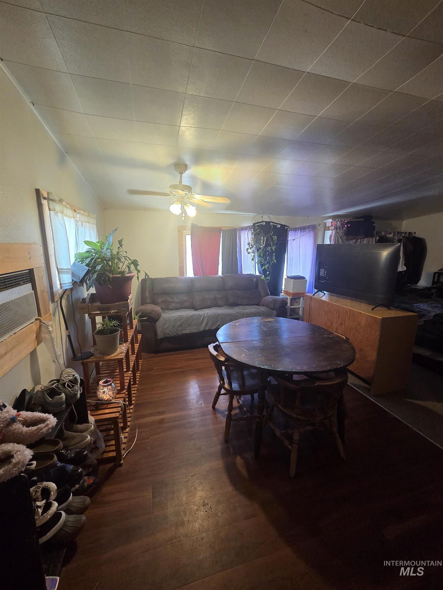 Dining space featuring wood finished floors, a ceiling fan, and plenty of natural light