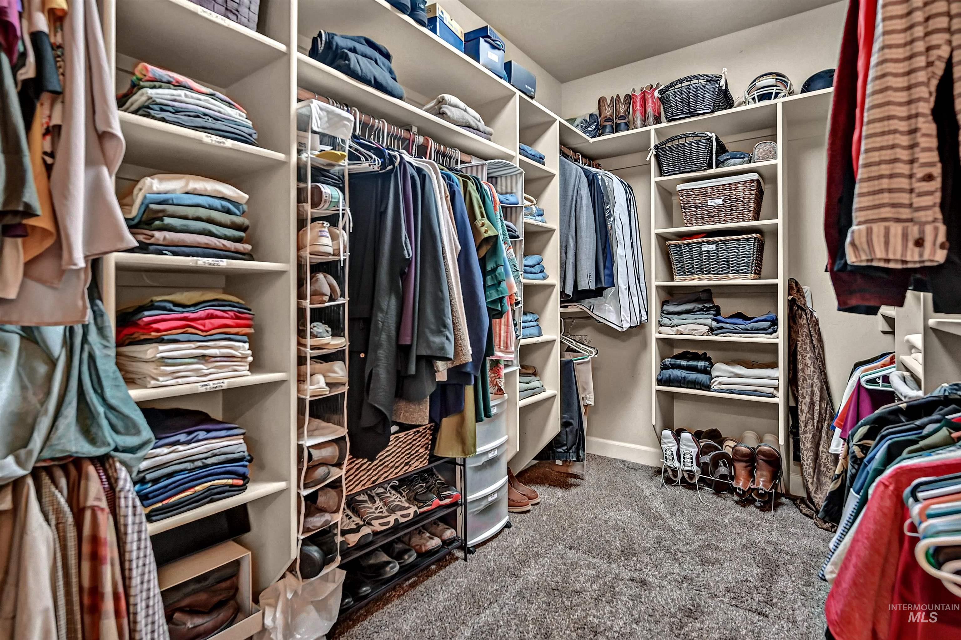 Walk in closet with light carpet