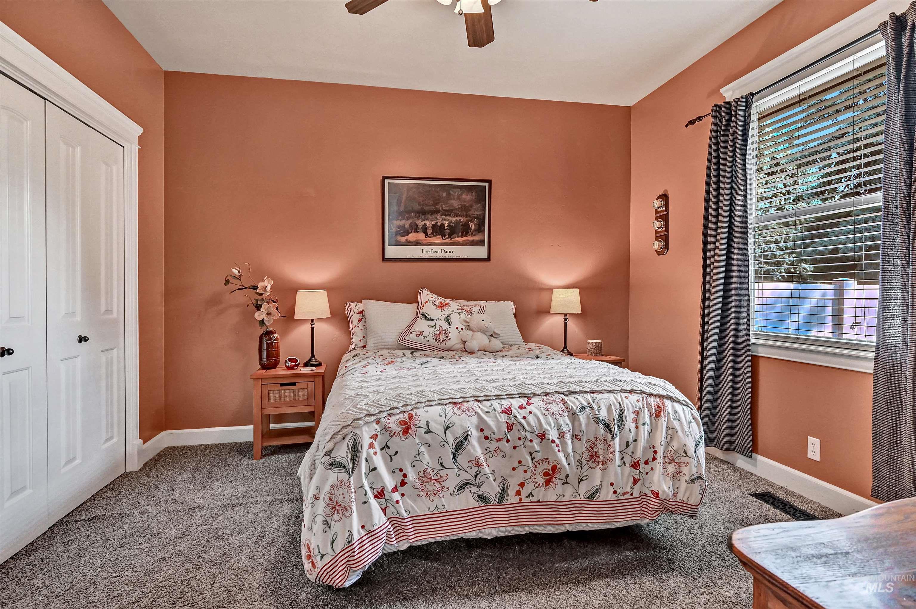 Carpeted bedroom featuring a closet and ceiling fan