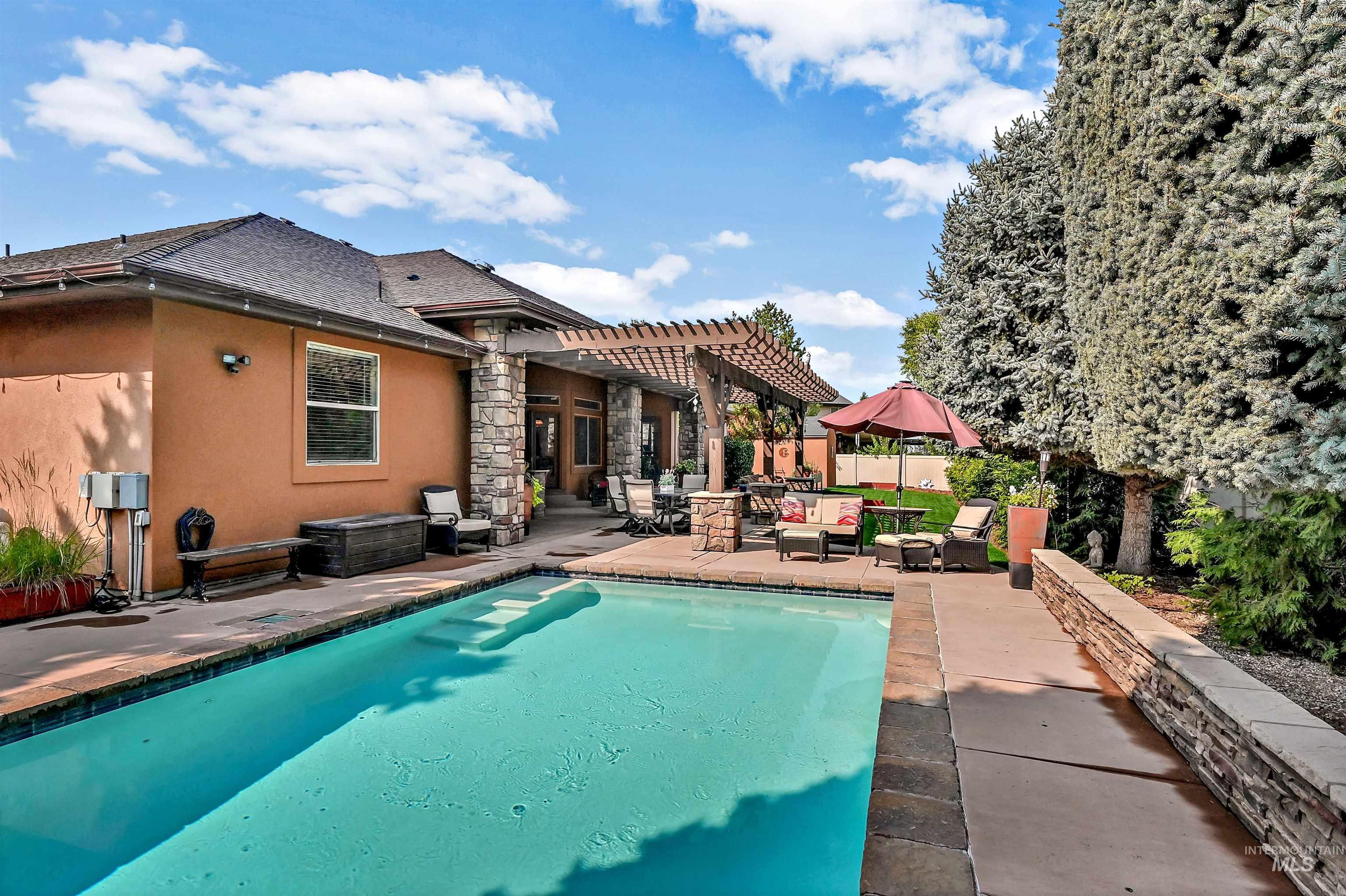 View of pool with a pergola and a patio area