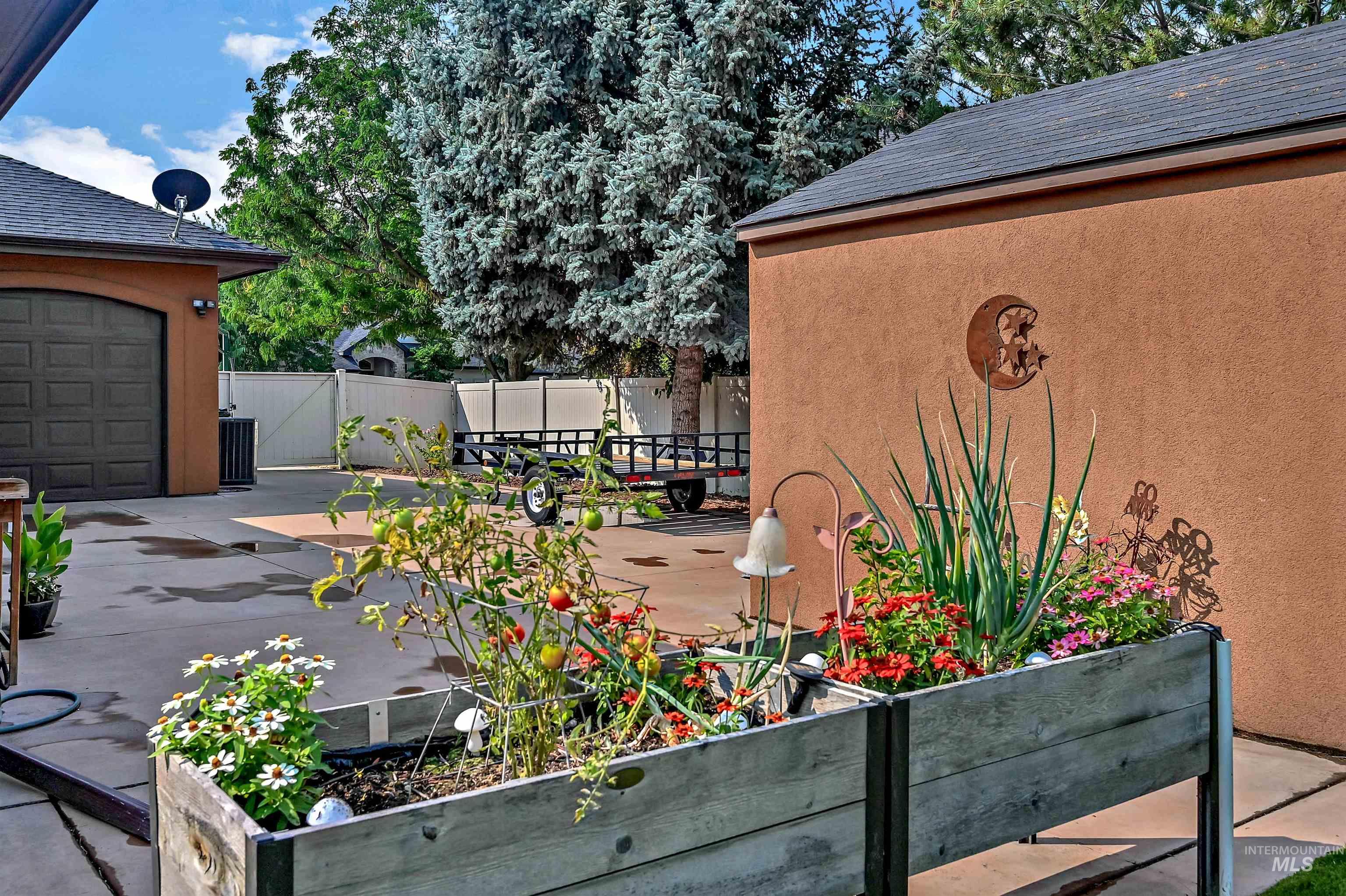 Wooden deck with a patio area and a vegetable garden