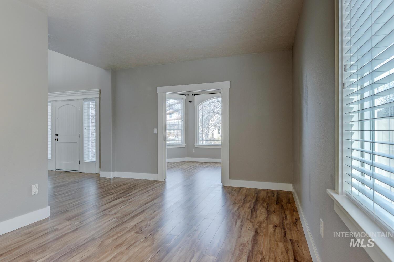 Entryway featuring wood finished floors and lofted ceiling