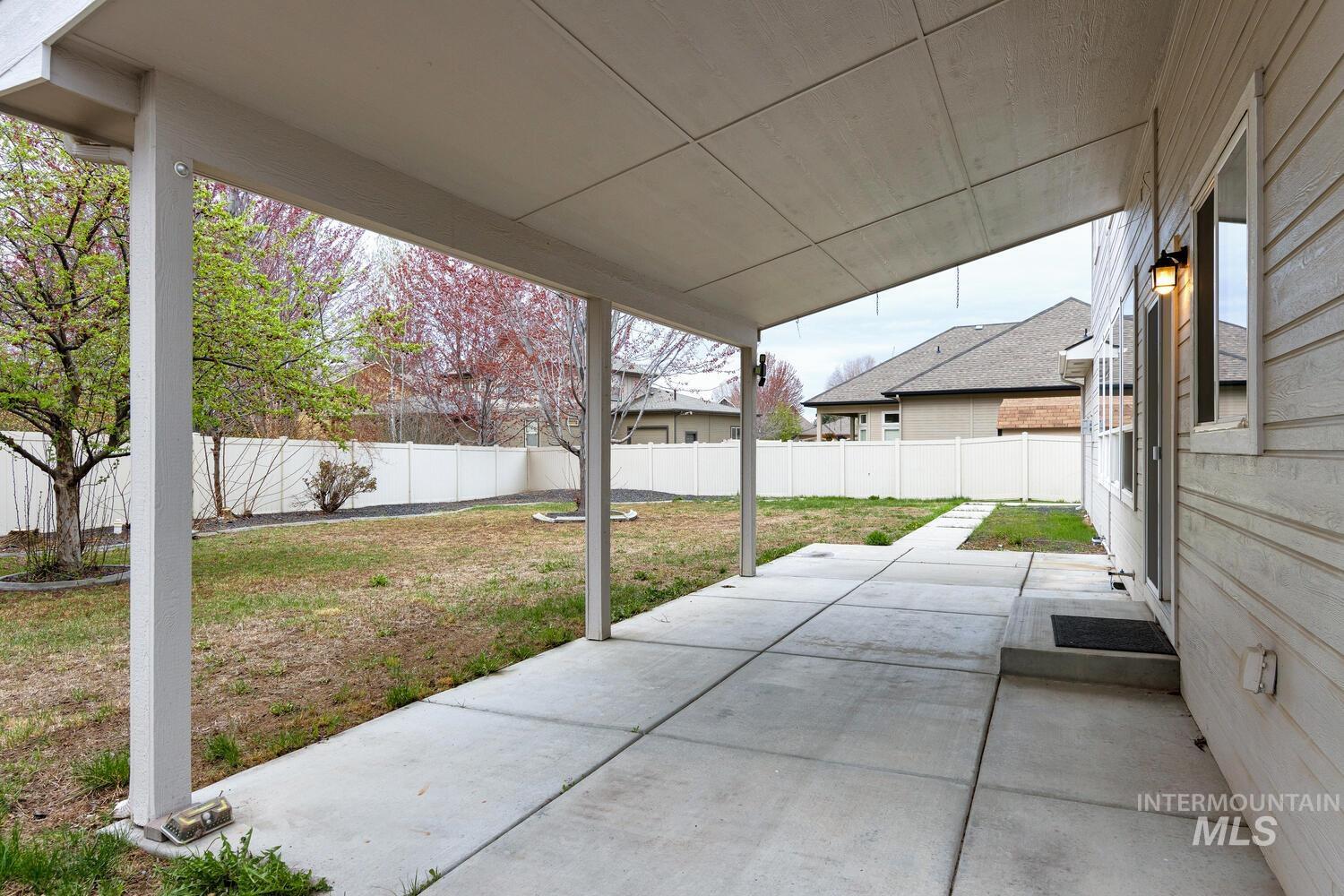 Fenced backyard featuring a patio