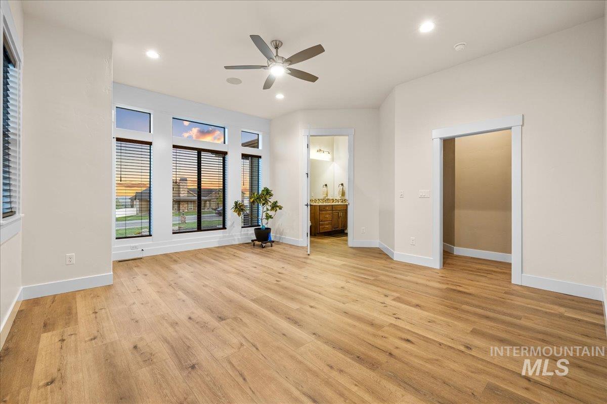 Unfurnished bedroom featuring recessed lighting, light wood finished floors, a ceiling fan, and connected bathroom