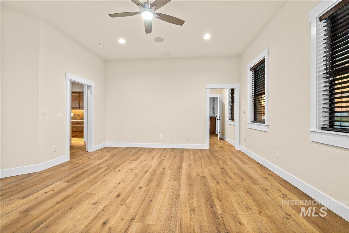 Empty room with light wood finished floors, recessed lighting, and a ceiling fan