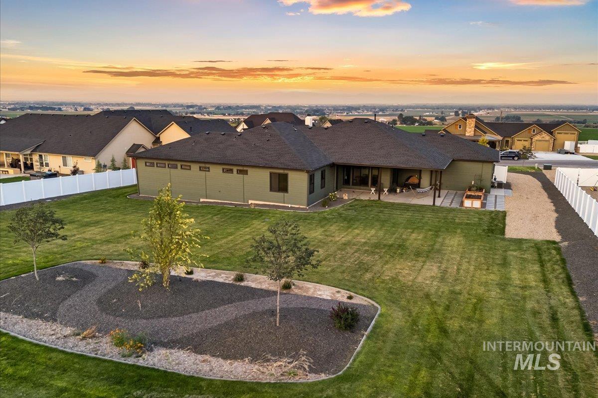 Back of property featuring a fenced backyard, a patio, and a residential view