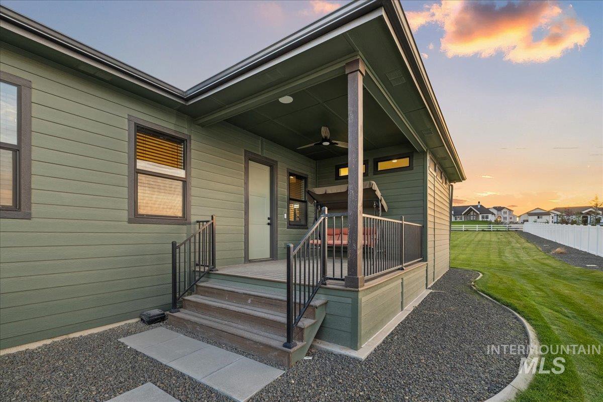 Property entrance featuring a ceiling fan and a deck