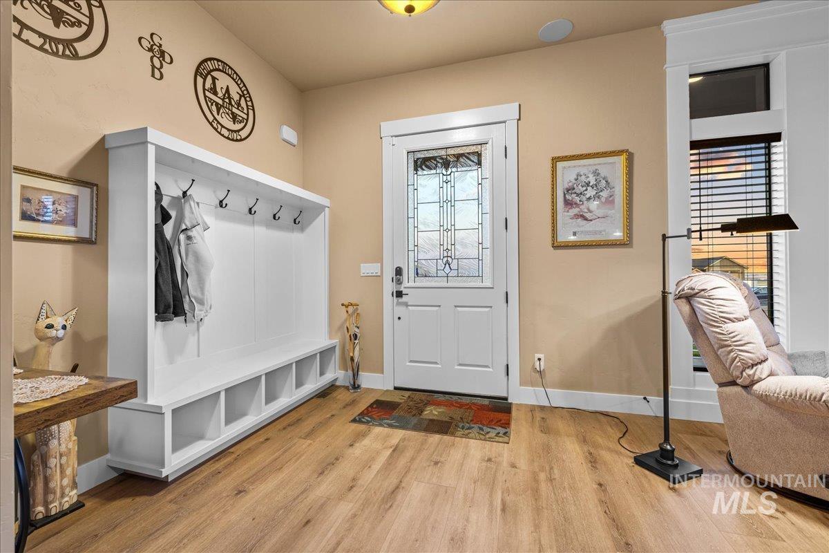 Mudroom featuring light wood-type flooring and baseboards