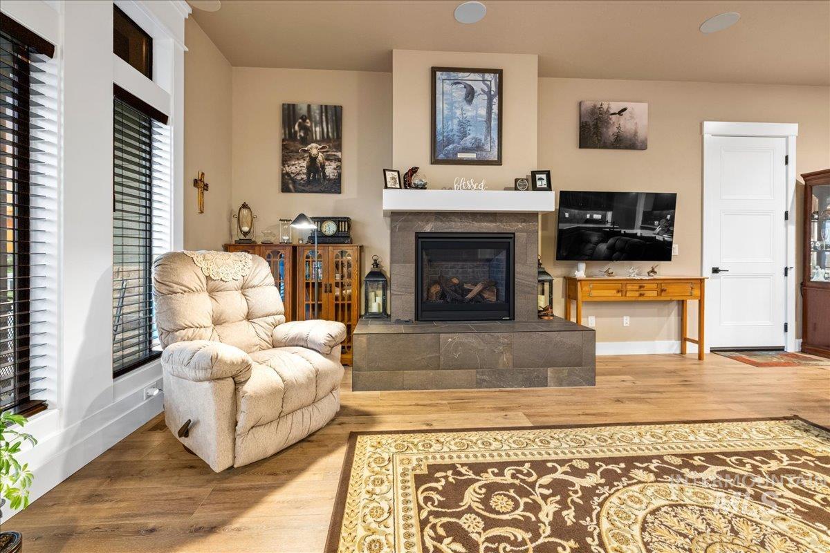 Living area with wood finished floors and a fireplace