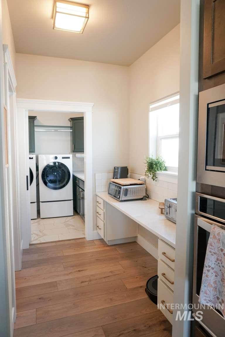 Washroom with an office area and light wood-style flooring