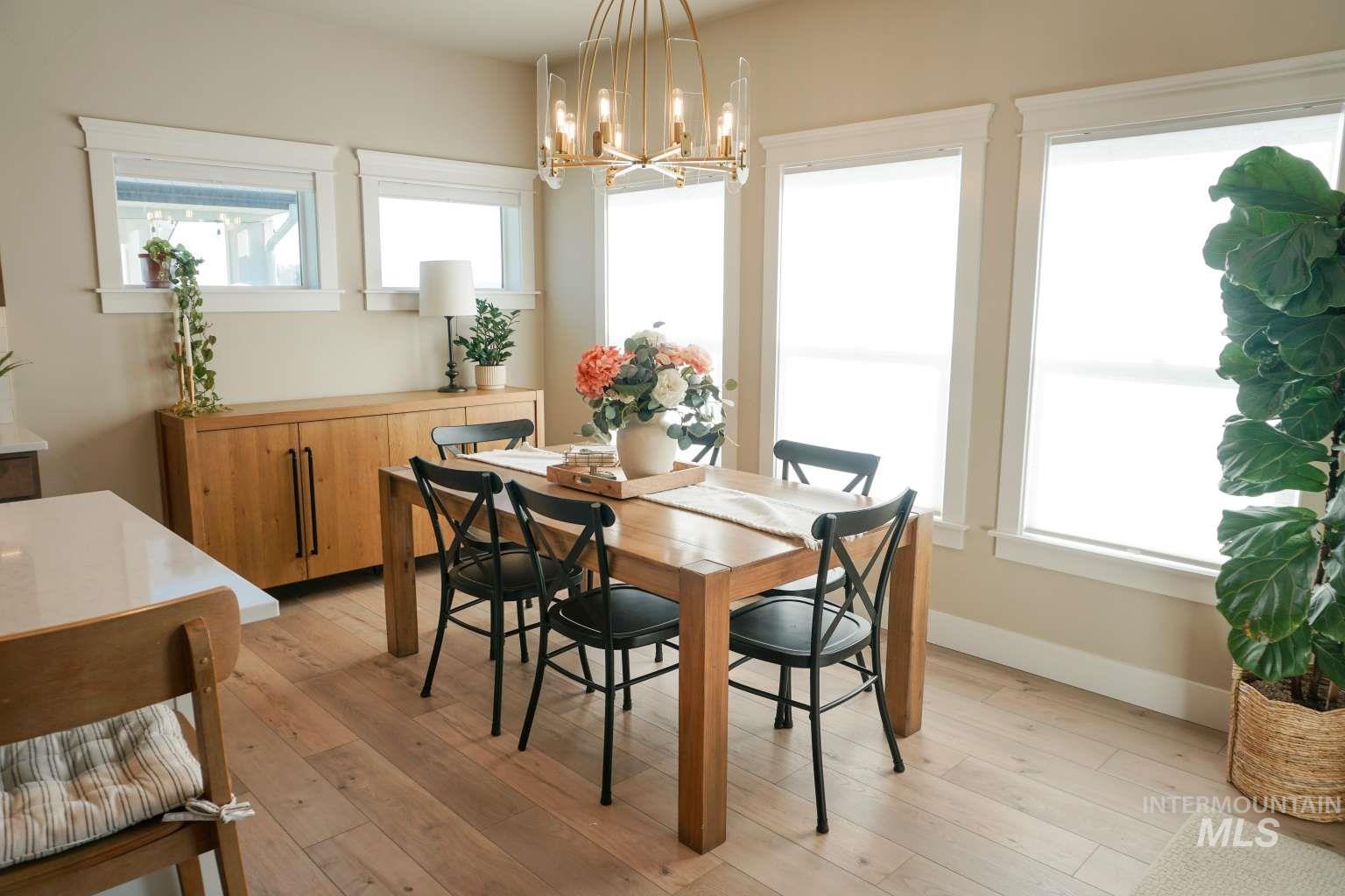 Dining area featuring light wood finished floors and a chandelier