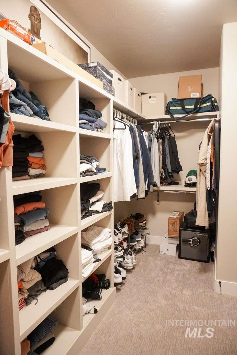 Spacious closet with light colored carpet