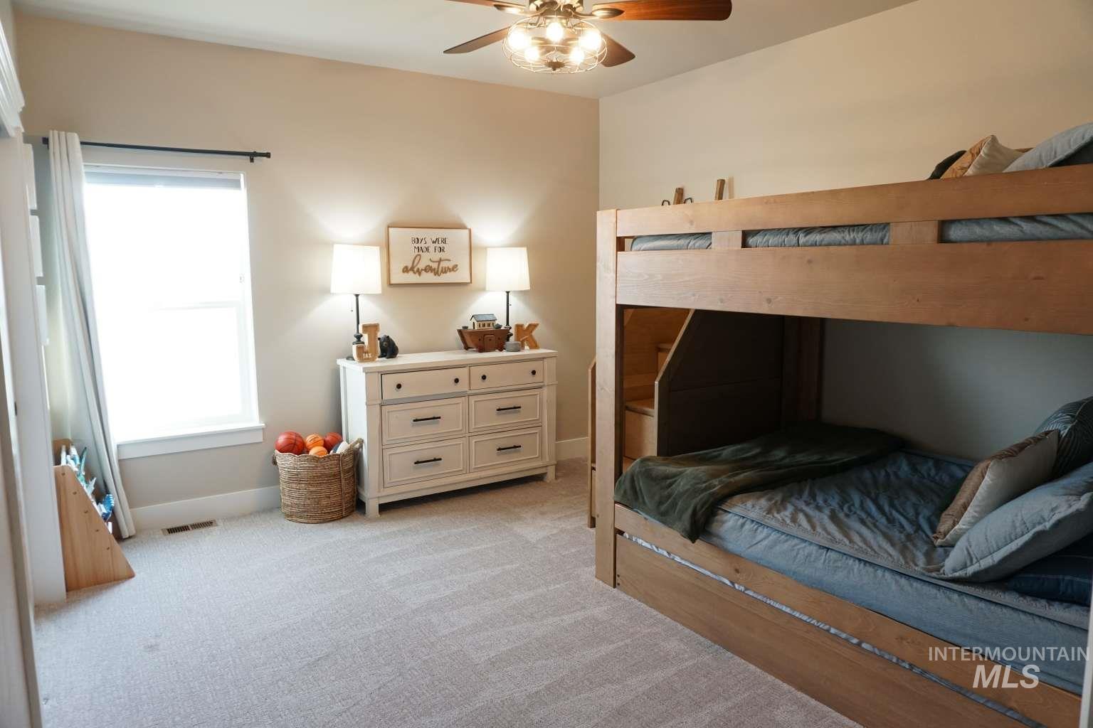 Bedroom with light carpet and ceiling fan