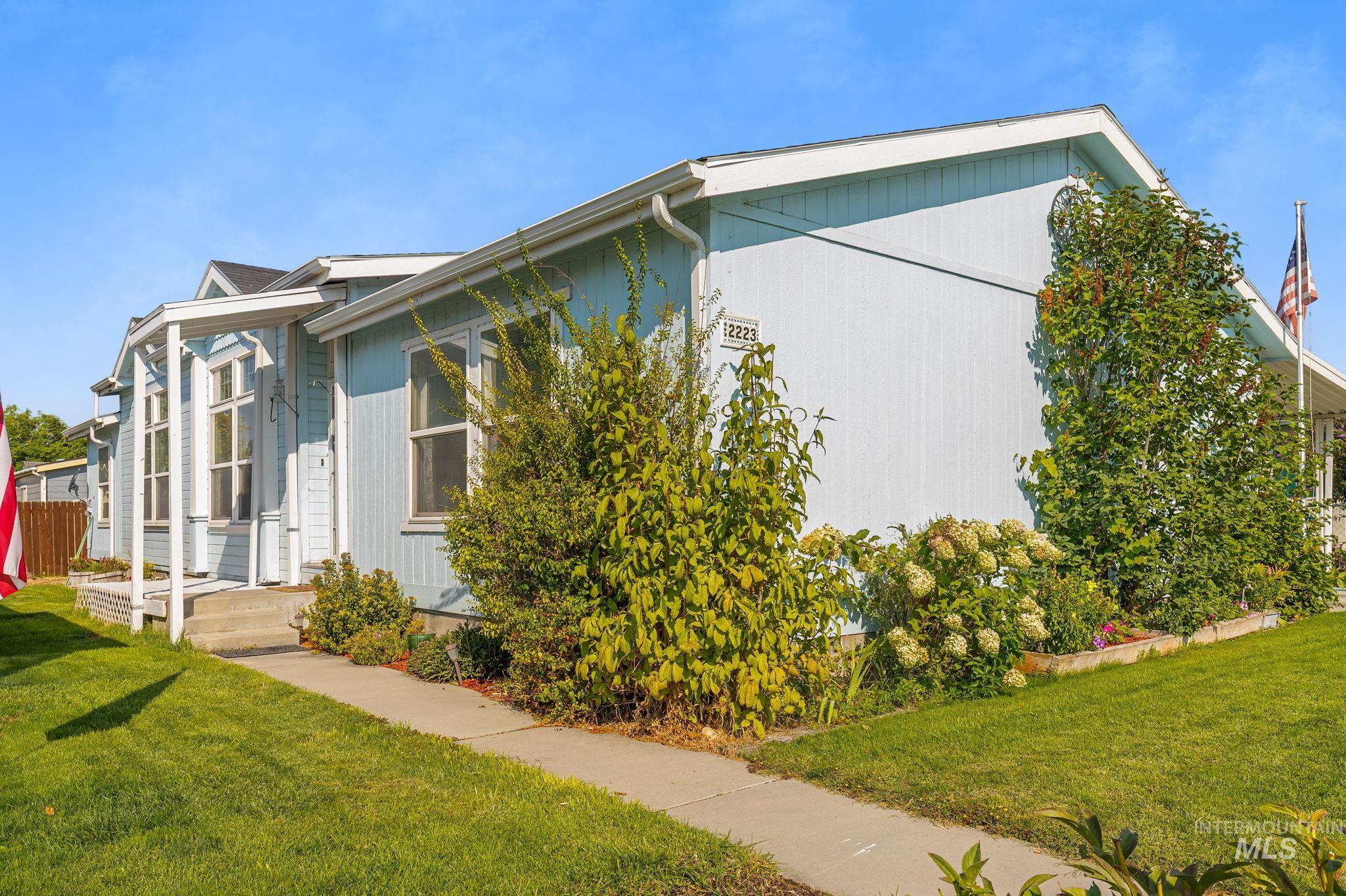 View of side of property with a lawn