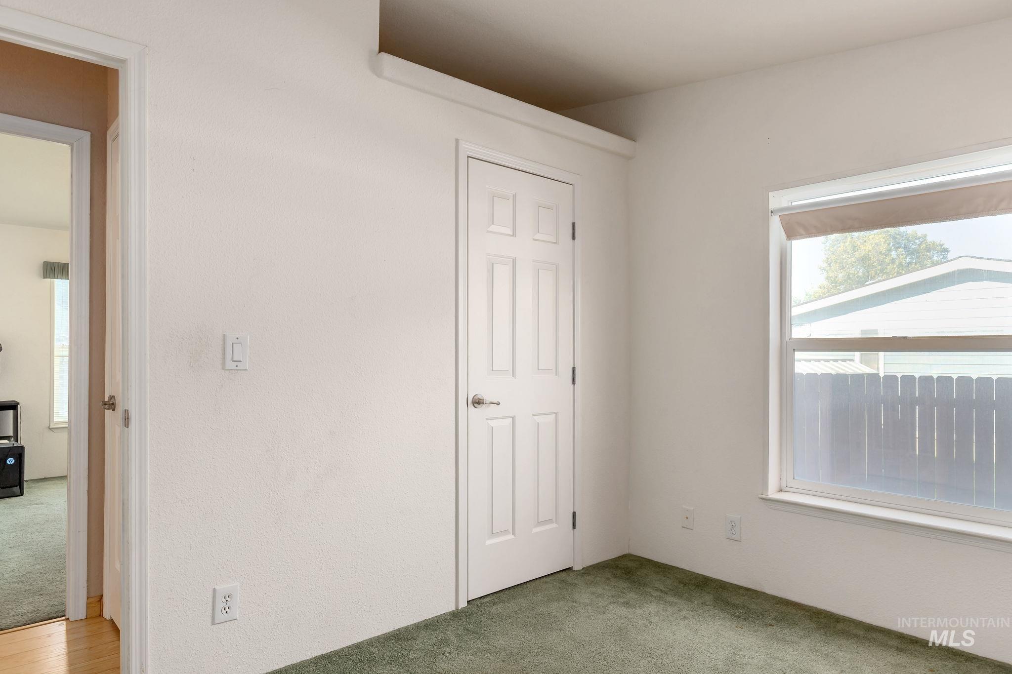 Unfurnished bedroom with light carpet