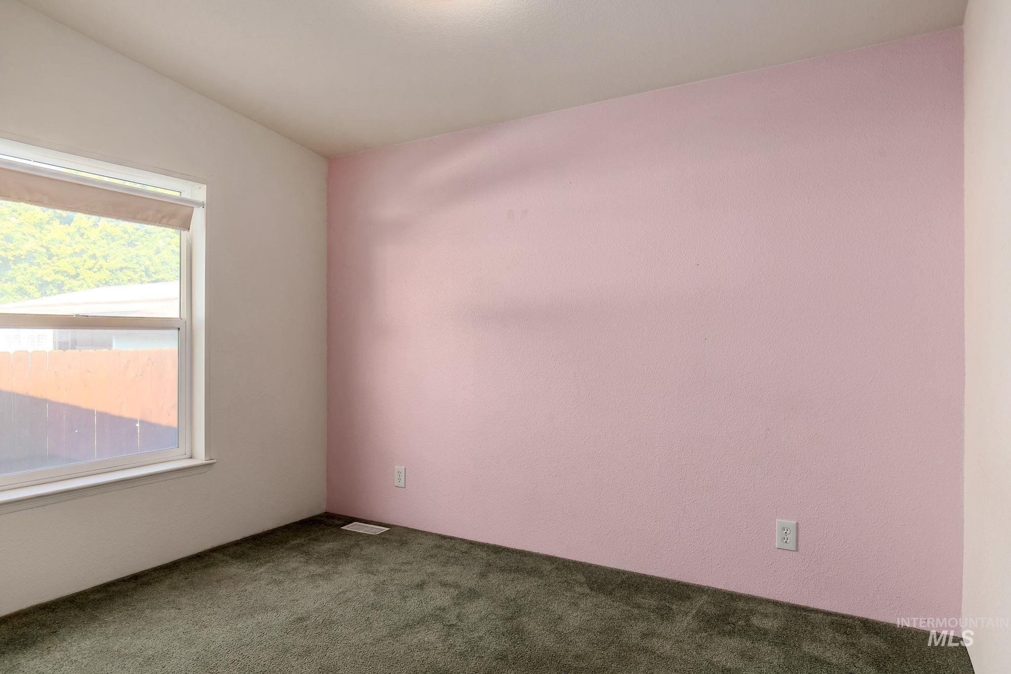 Spare room with carpet flooring and lofted ceiling
