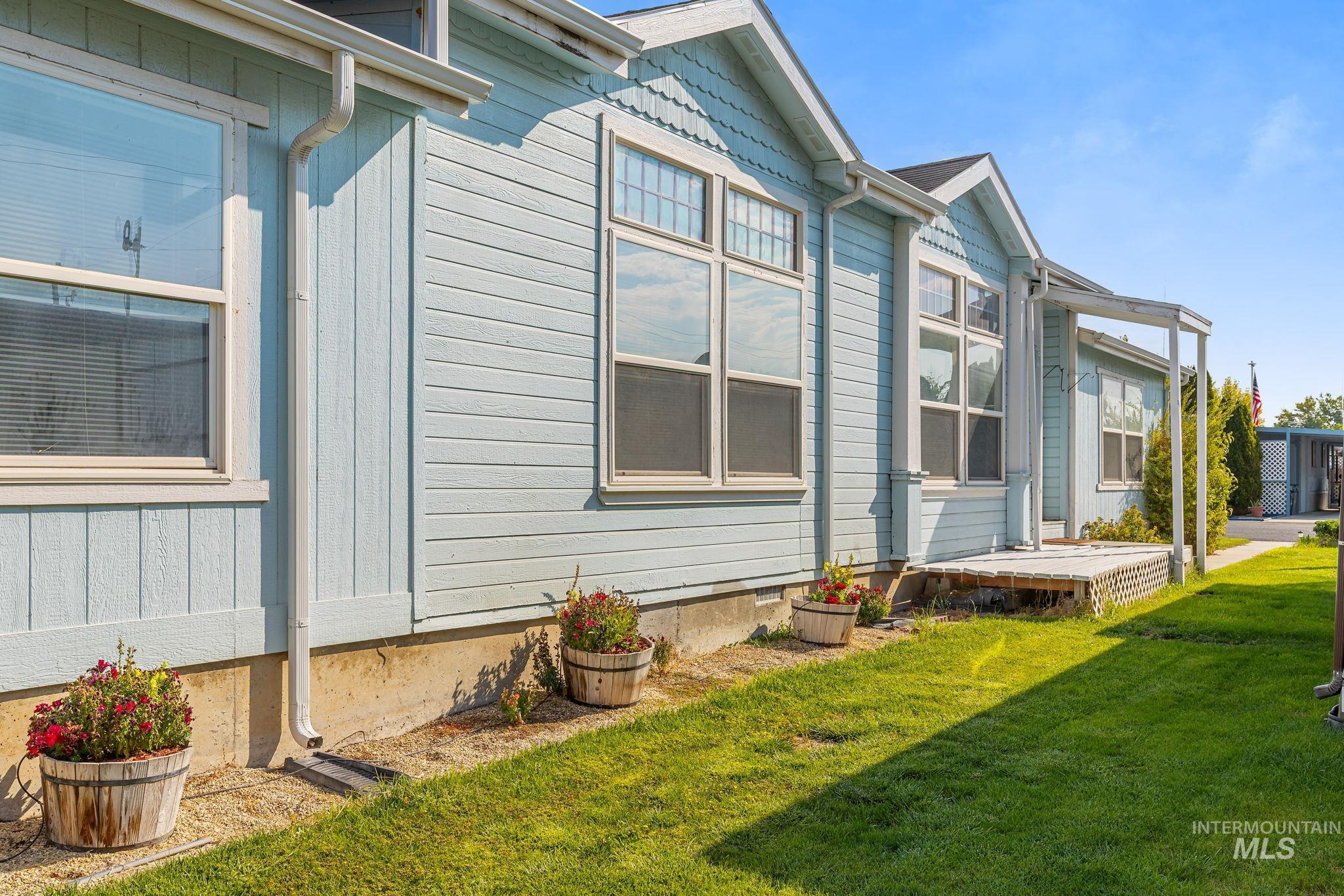 View of side of property featuring a yard