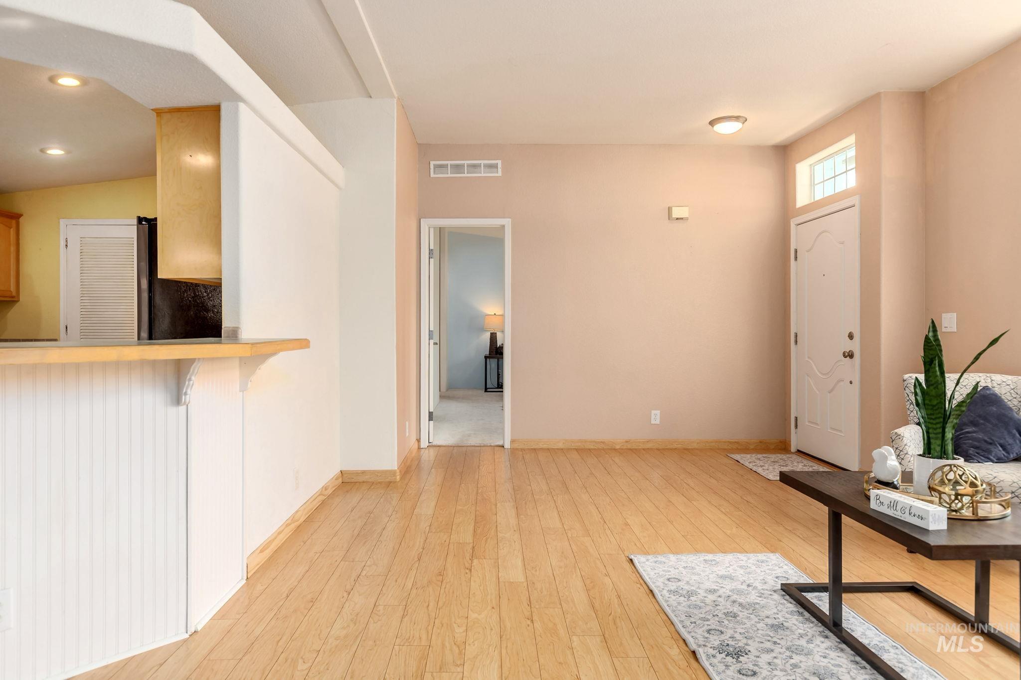 Foyer featuring light wood finished floors and baseboards