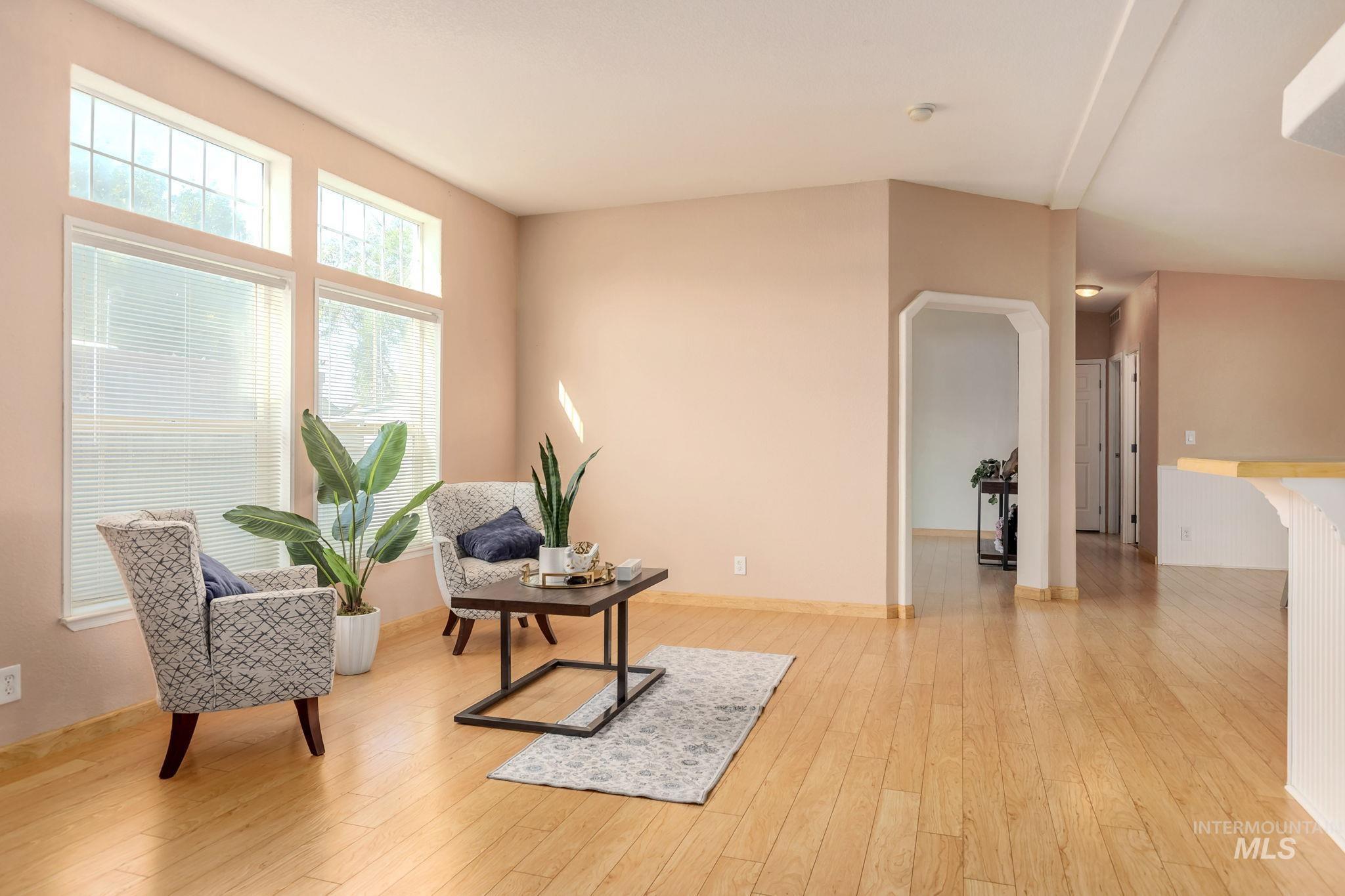 Sitting room featuring light wood-type flooring and arched walkways