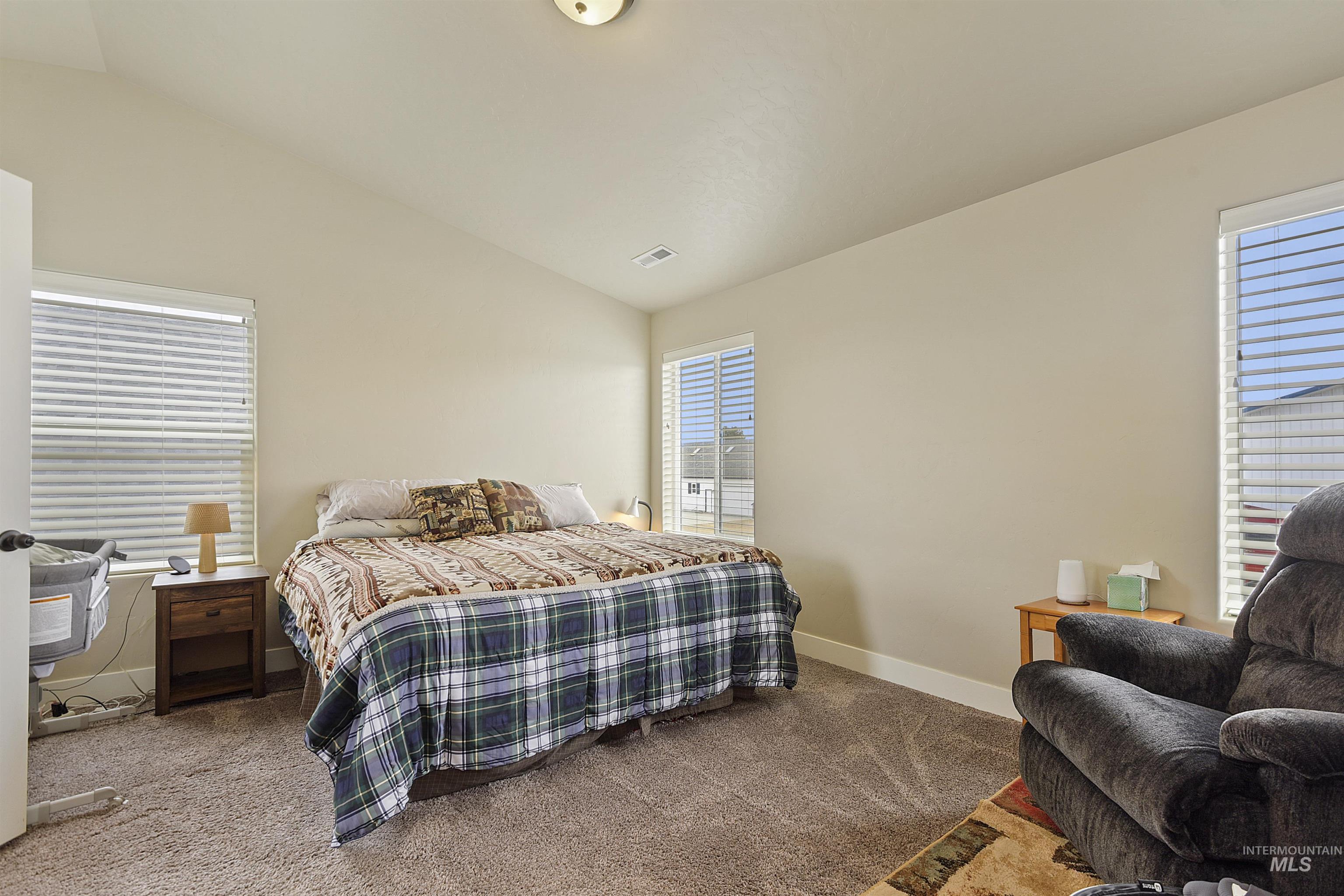 Bedroom featuring vaulted ceiling and carpet floors