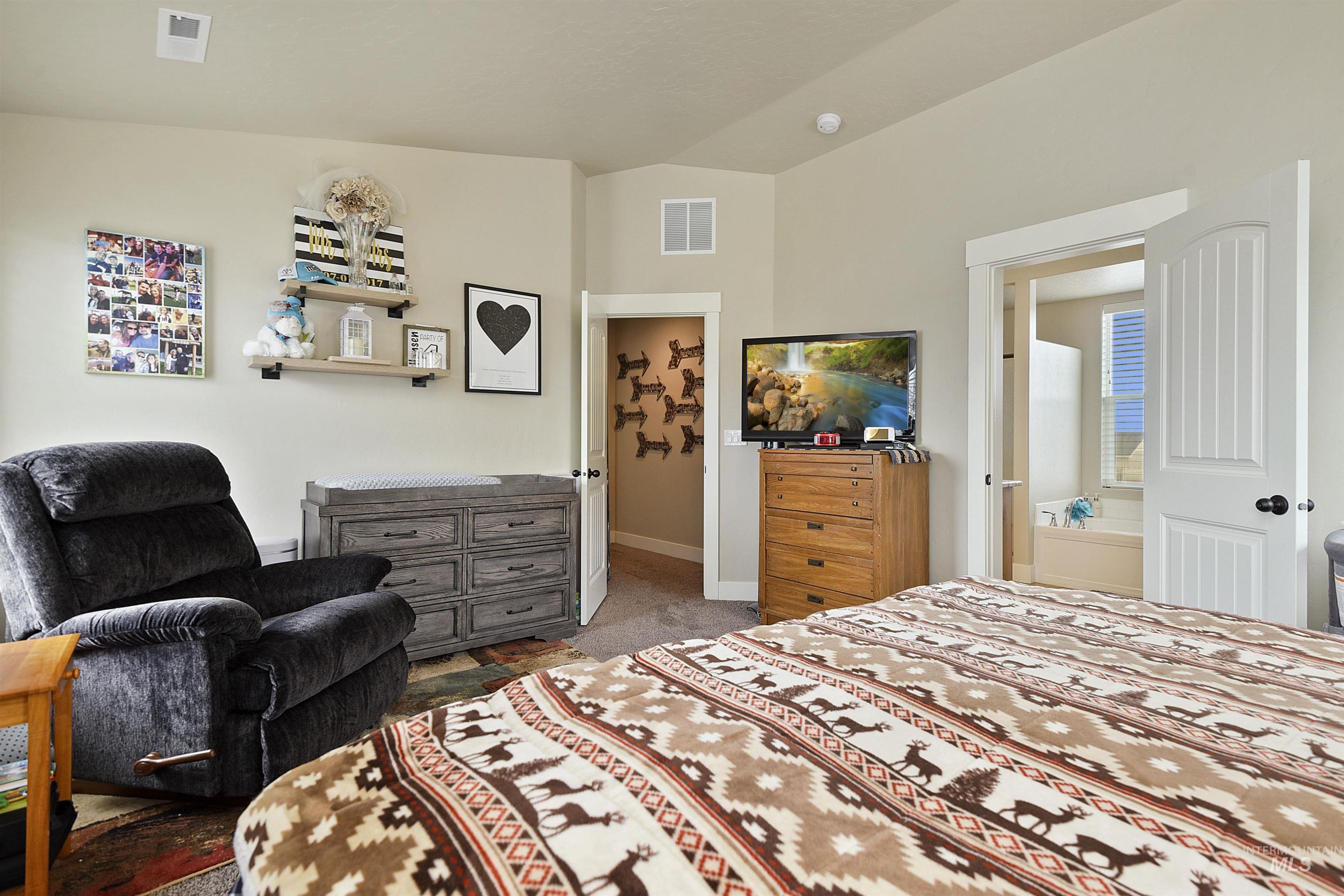 Carpeted bedroom featuring baseboards