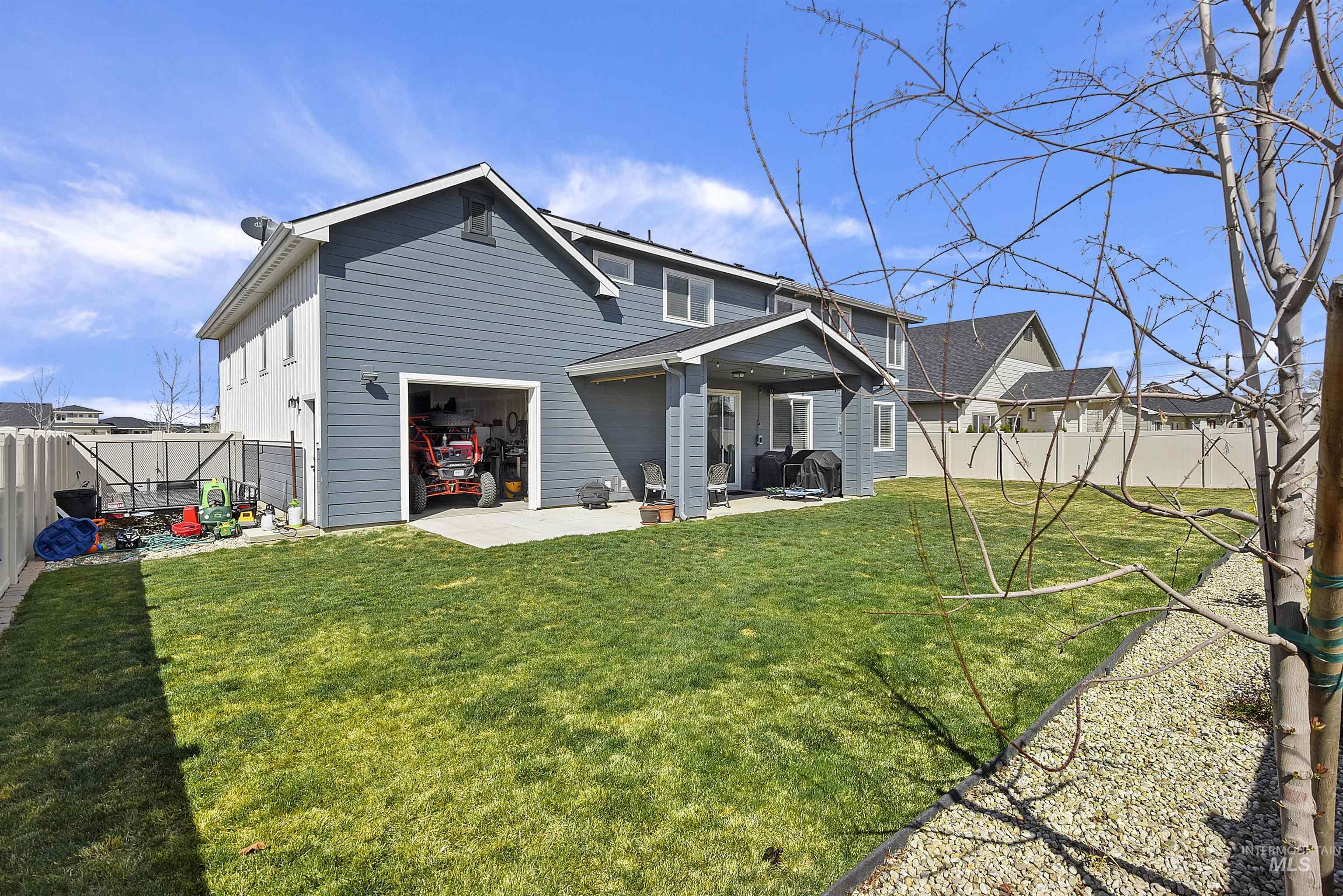 Rear view of house featuring a patio area and a fenced backyard