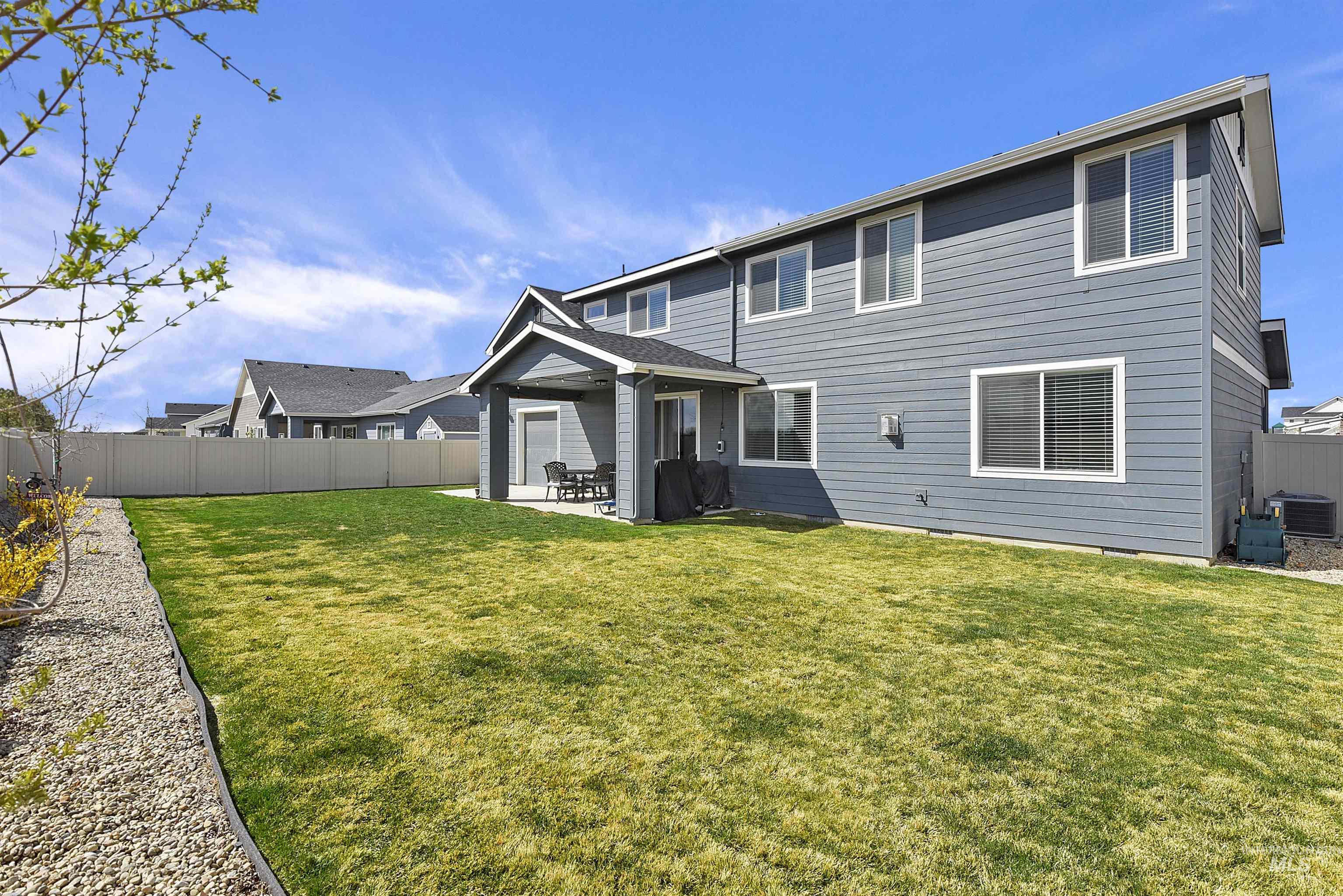 Back of property with a patio and a fenced backyard
