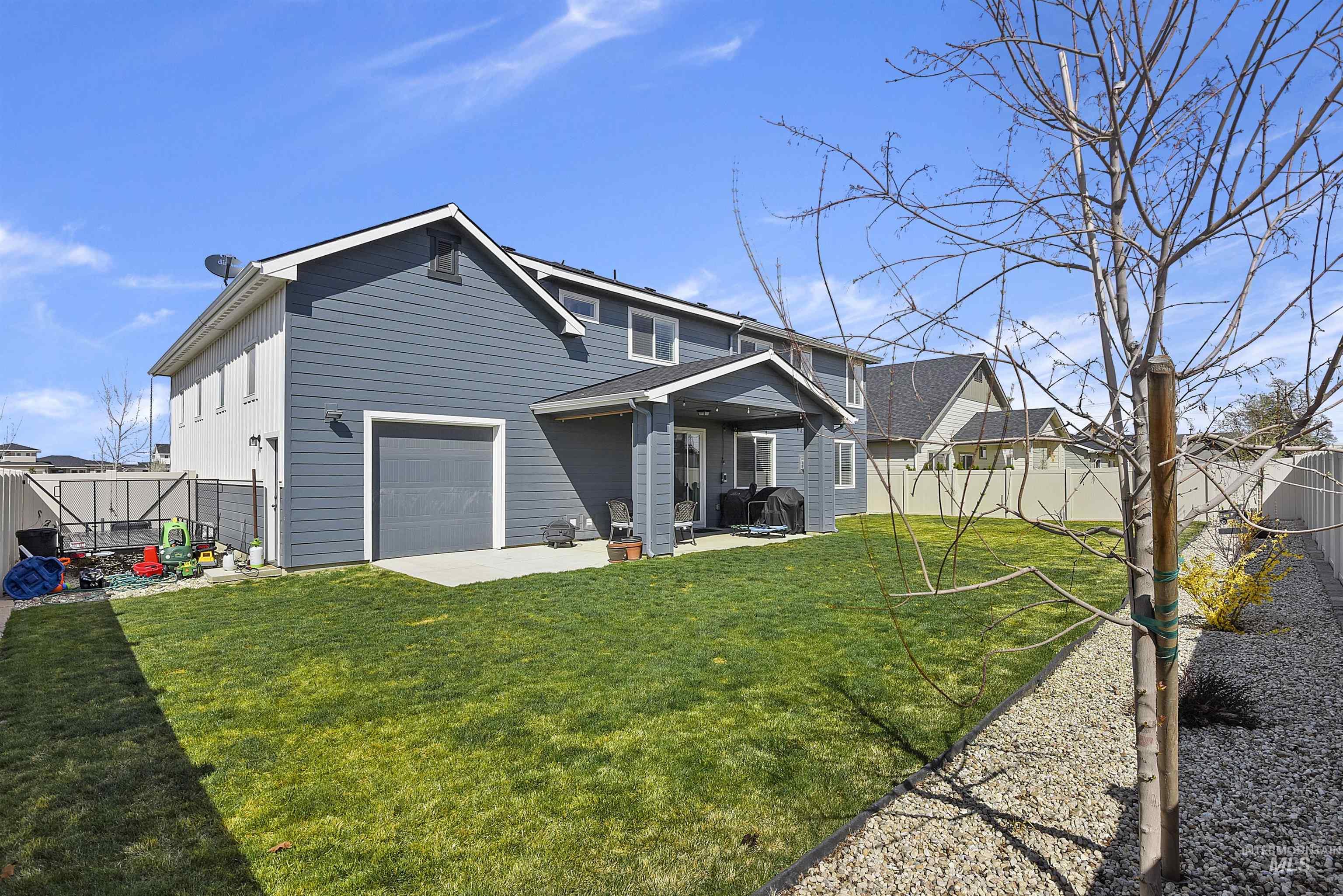 Rear view of house with a patio area and a fenced backyard
