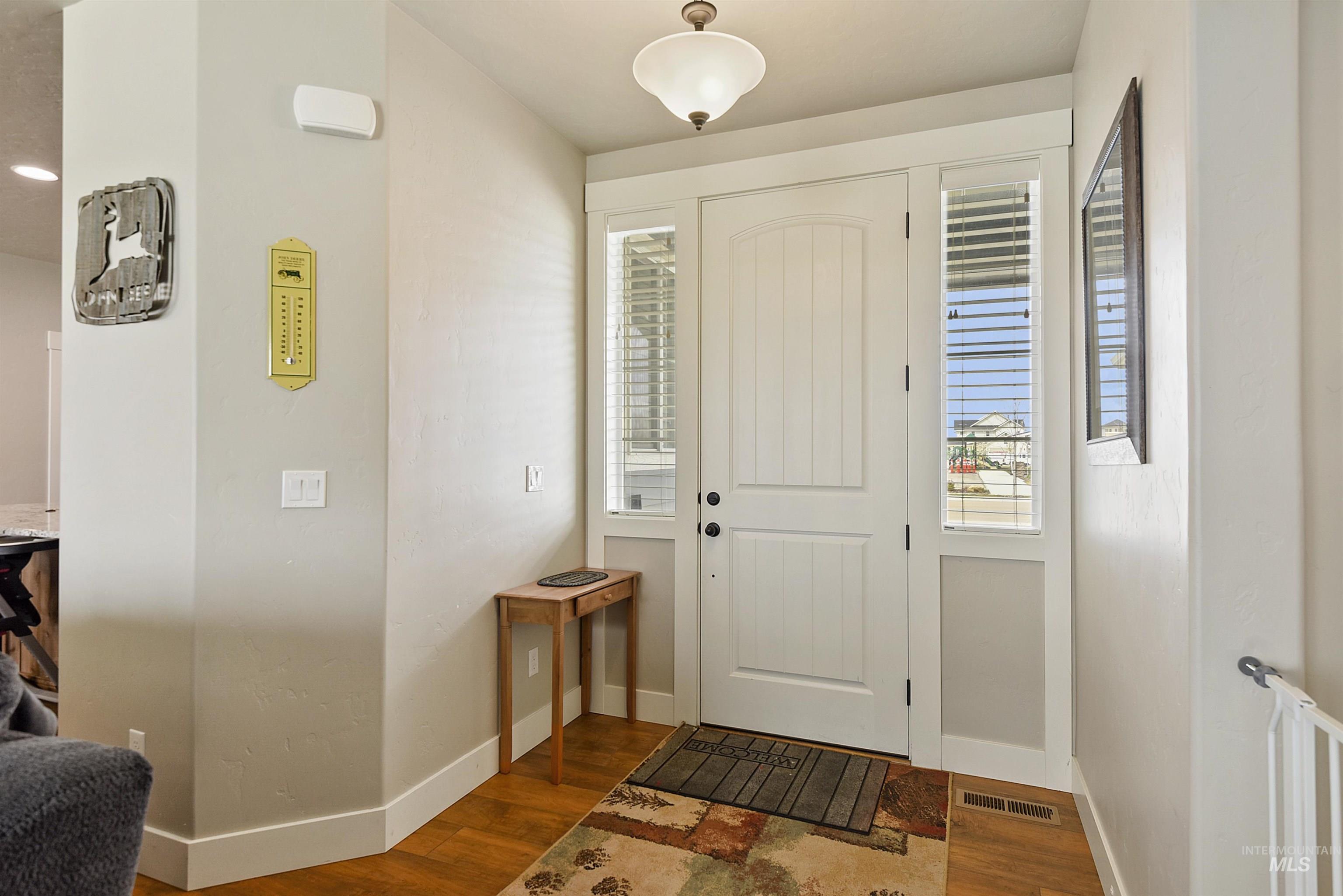 Entrance foyer with wood finished floors