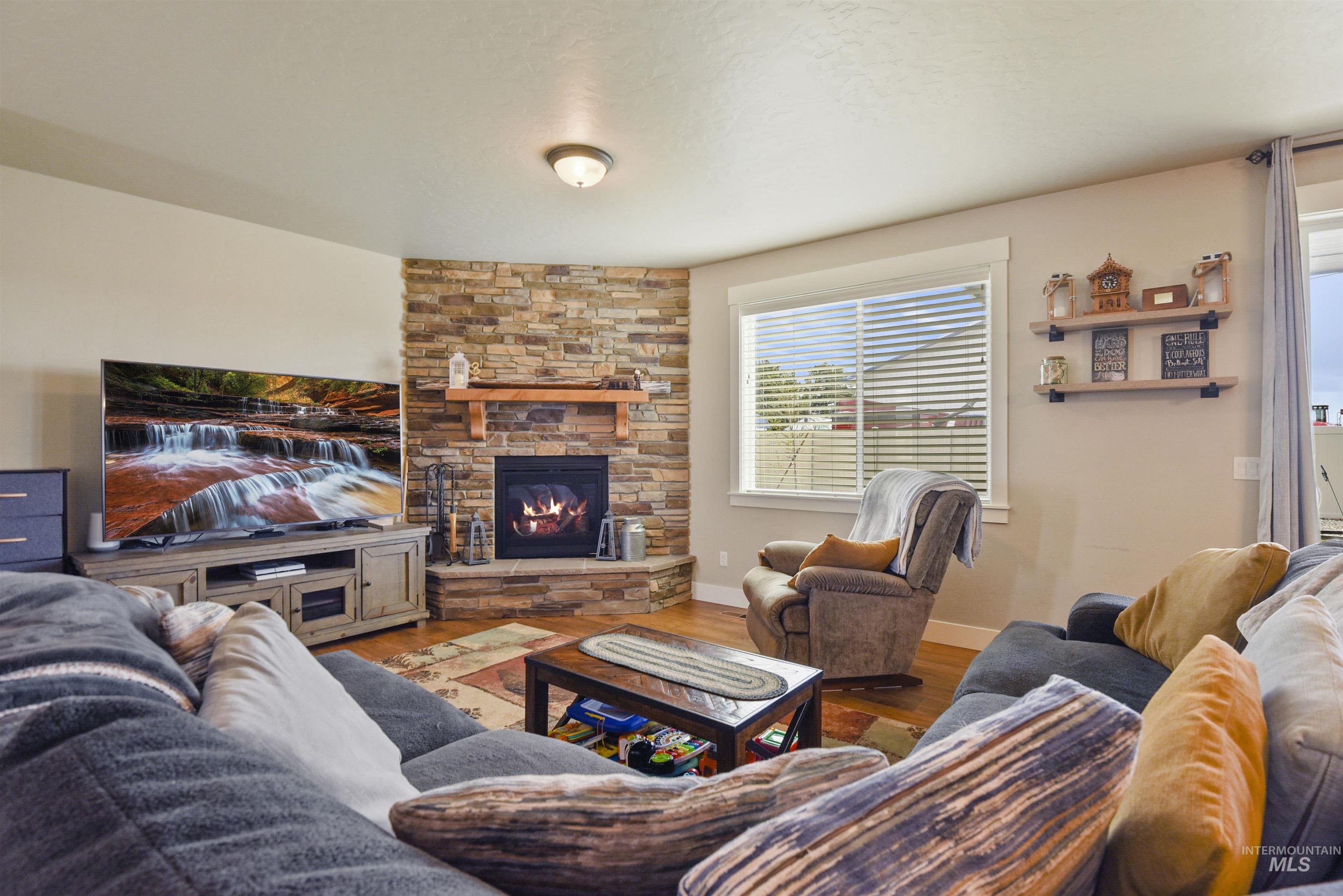 Living area with a fireplace and wood finished floors