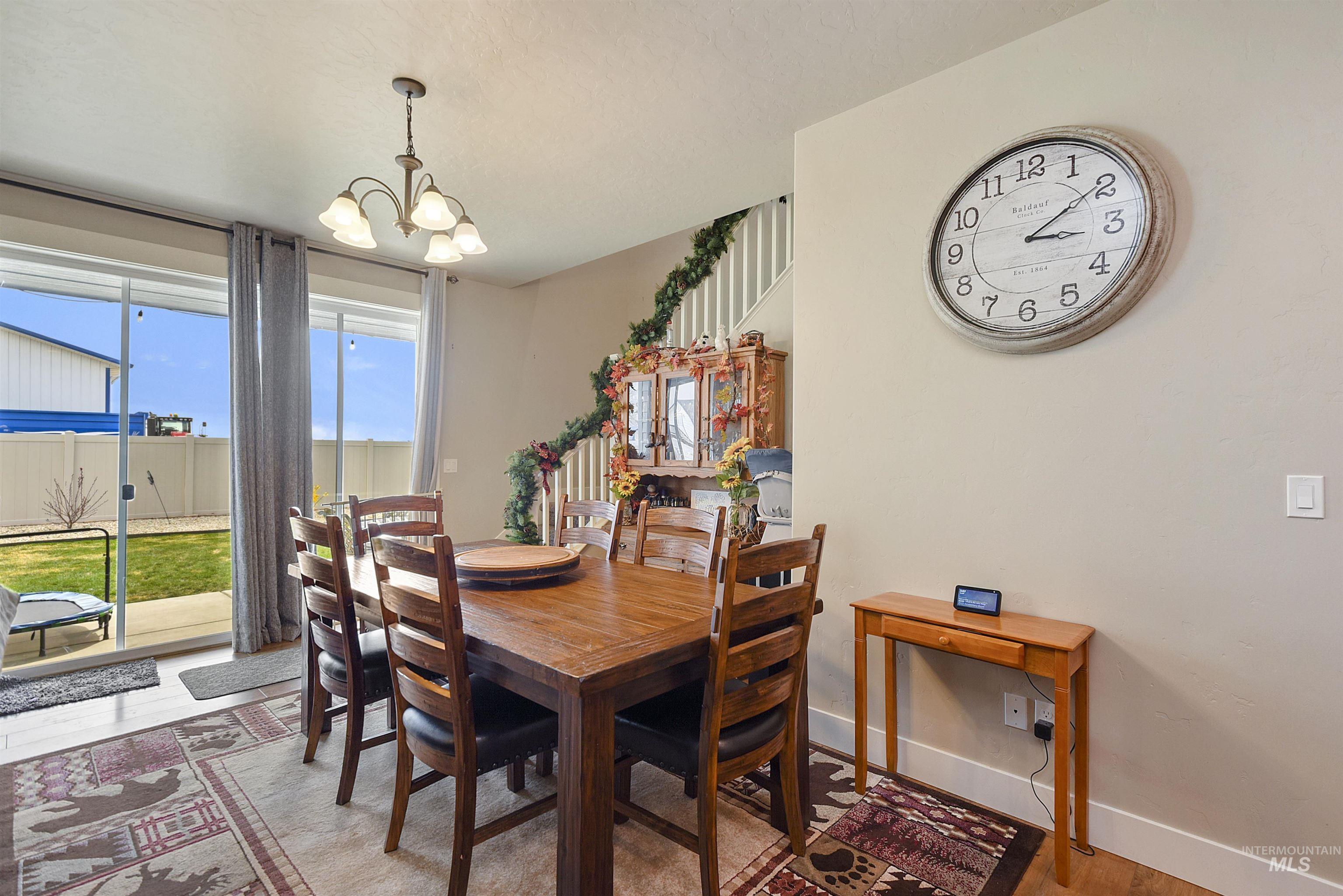 Dining area with a chandelier and light wood-type flooring