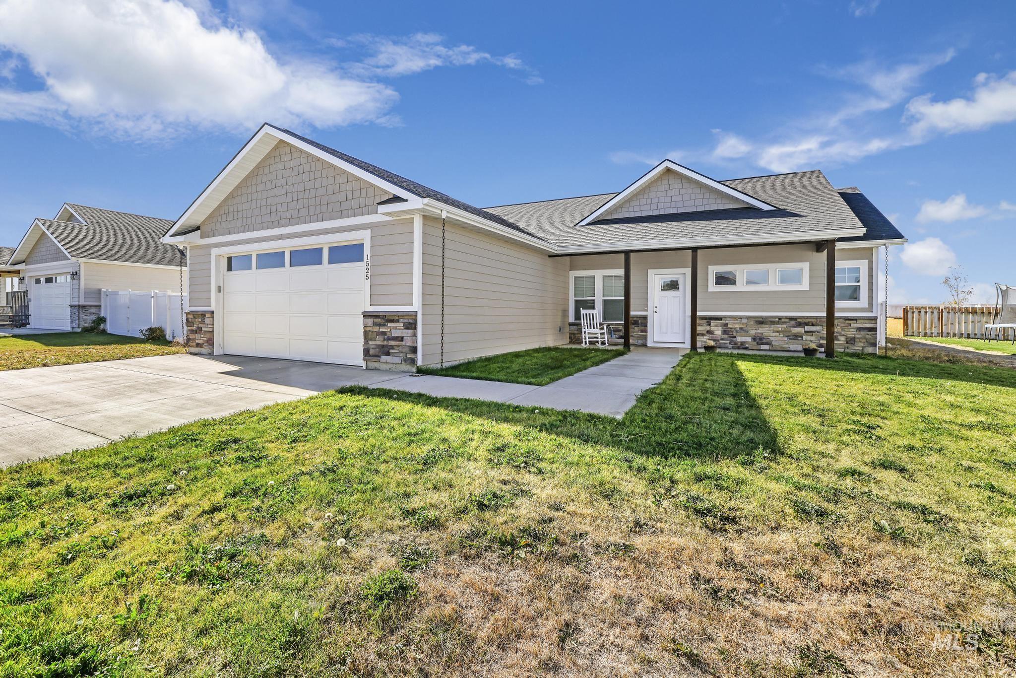 Craftsman inspired home with stone siding, driveway, a garage, and roof with shingles