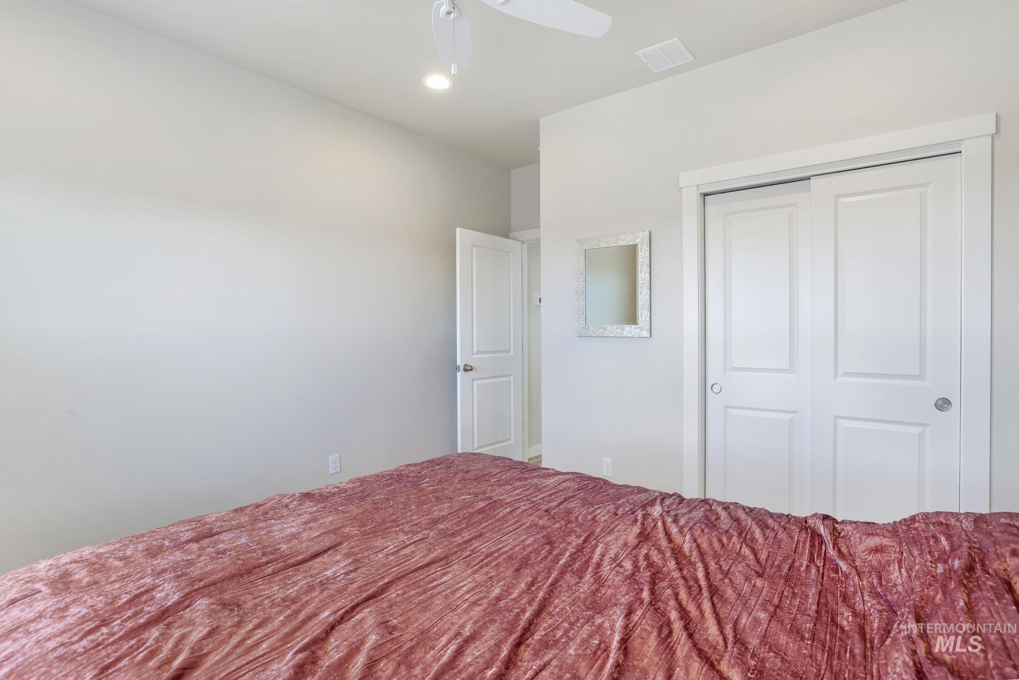 Bedroom featuring a ceiling fan, a closet, and recessed lighting