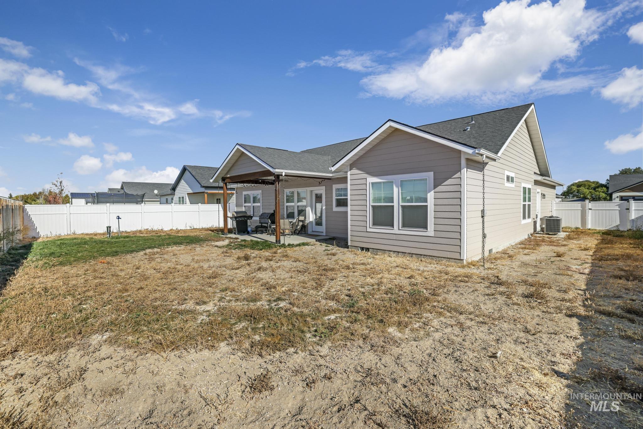 View of front of home featuring a fenced backyard, a patio area, and ceiling fan