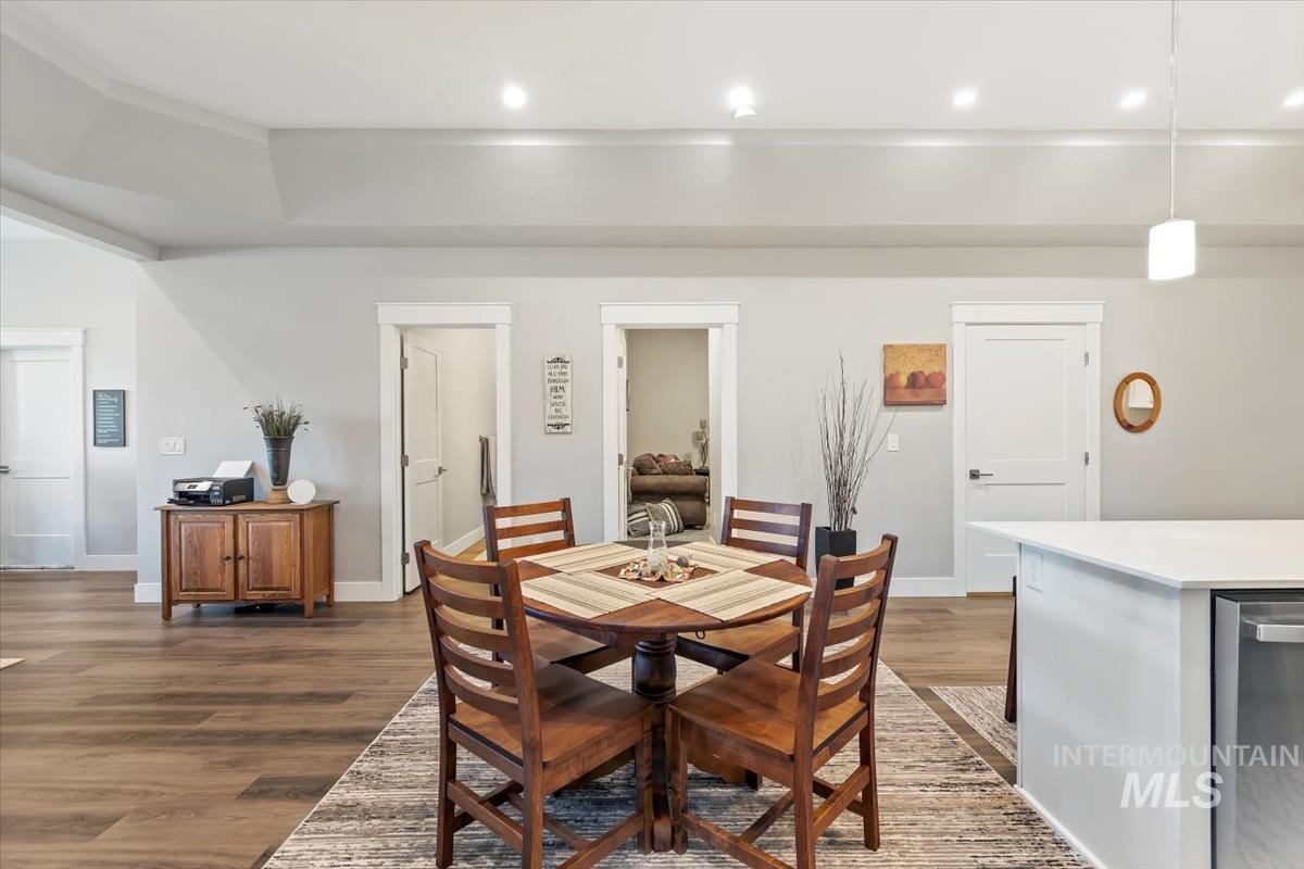 Dining space featuring dark wood finished floors and recessed lighting