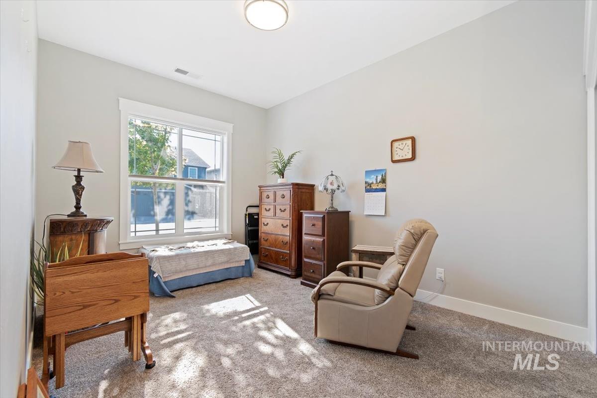 Bedroom 3 at the front of the home with carpet flooring and baseboards