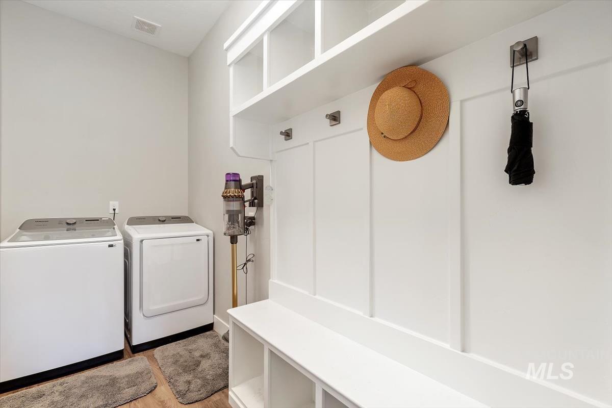 Laundry room featuring washing machine and dryer and light wood-style floors