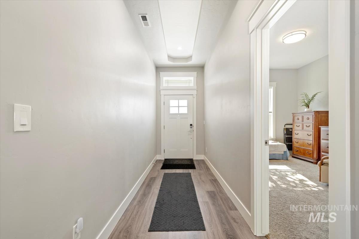Entryway with baseboards and wood finished floors