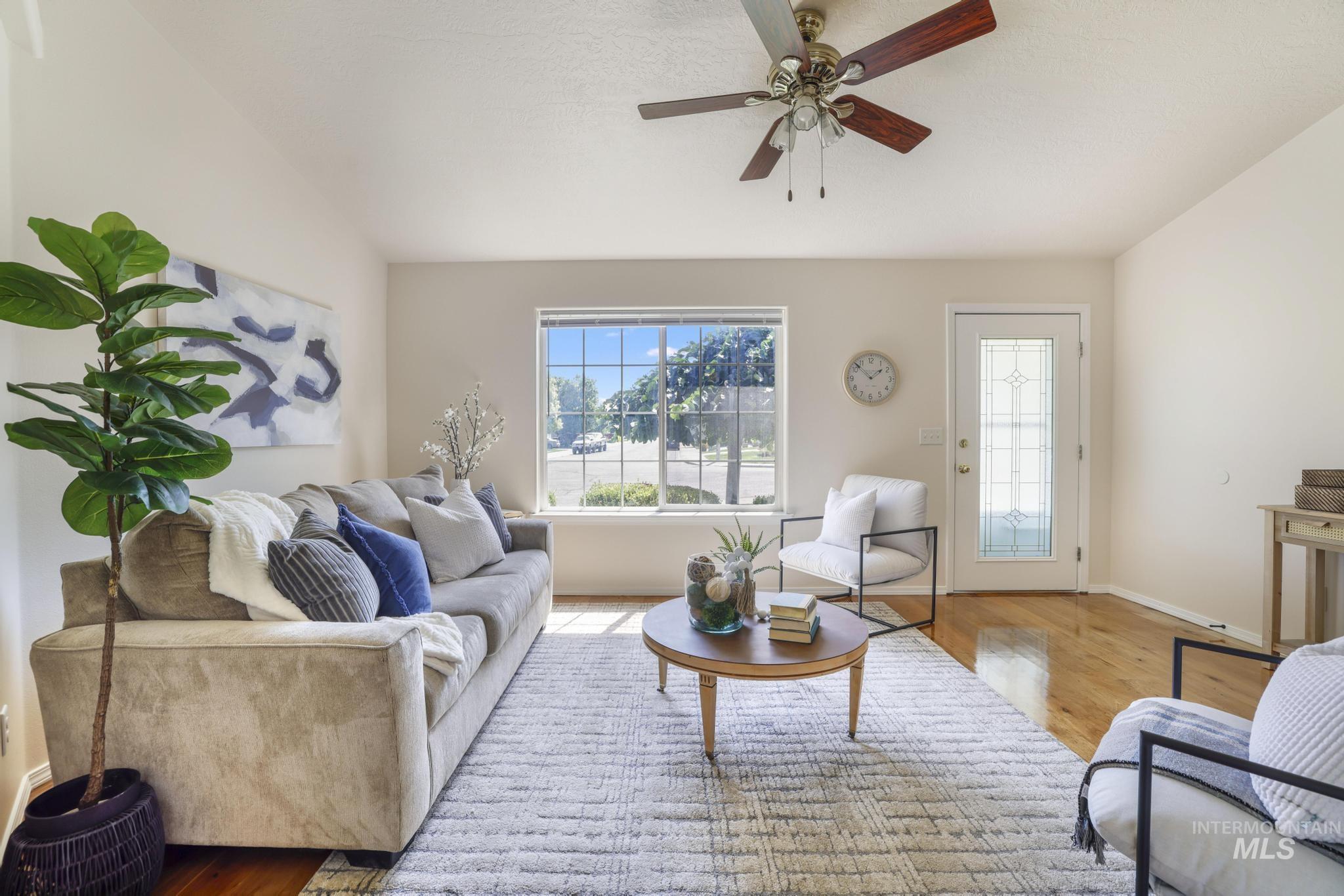 Living room featuring wood finished floors and a ceiling fan