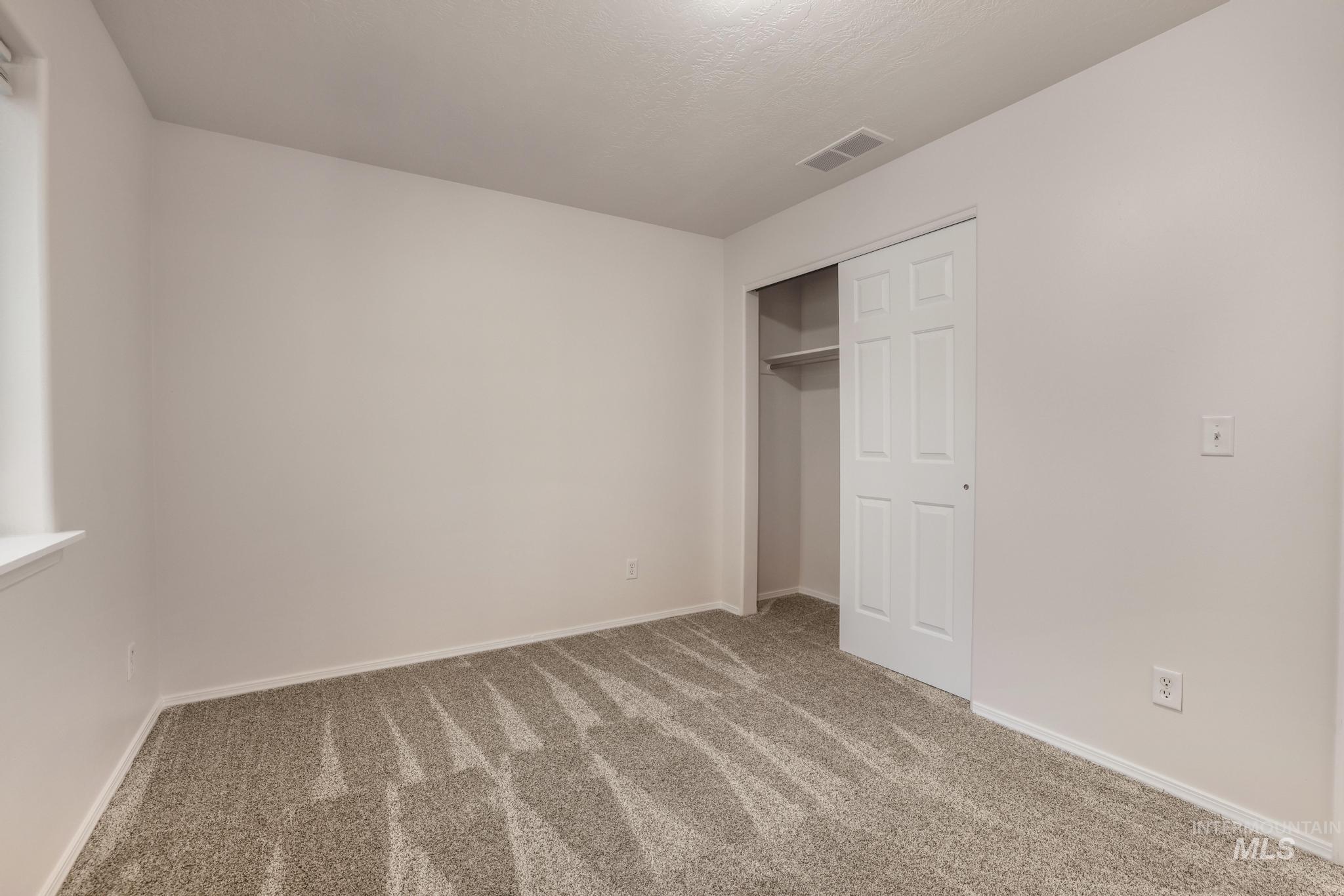 Unfurnished bedroom with carpet floors and a closet