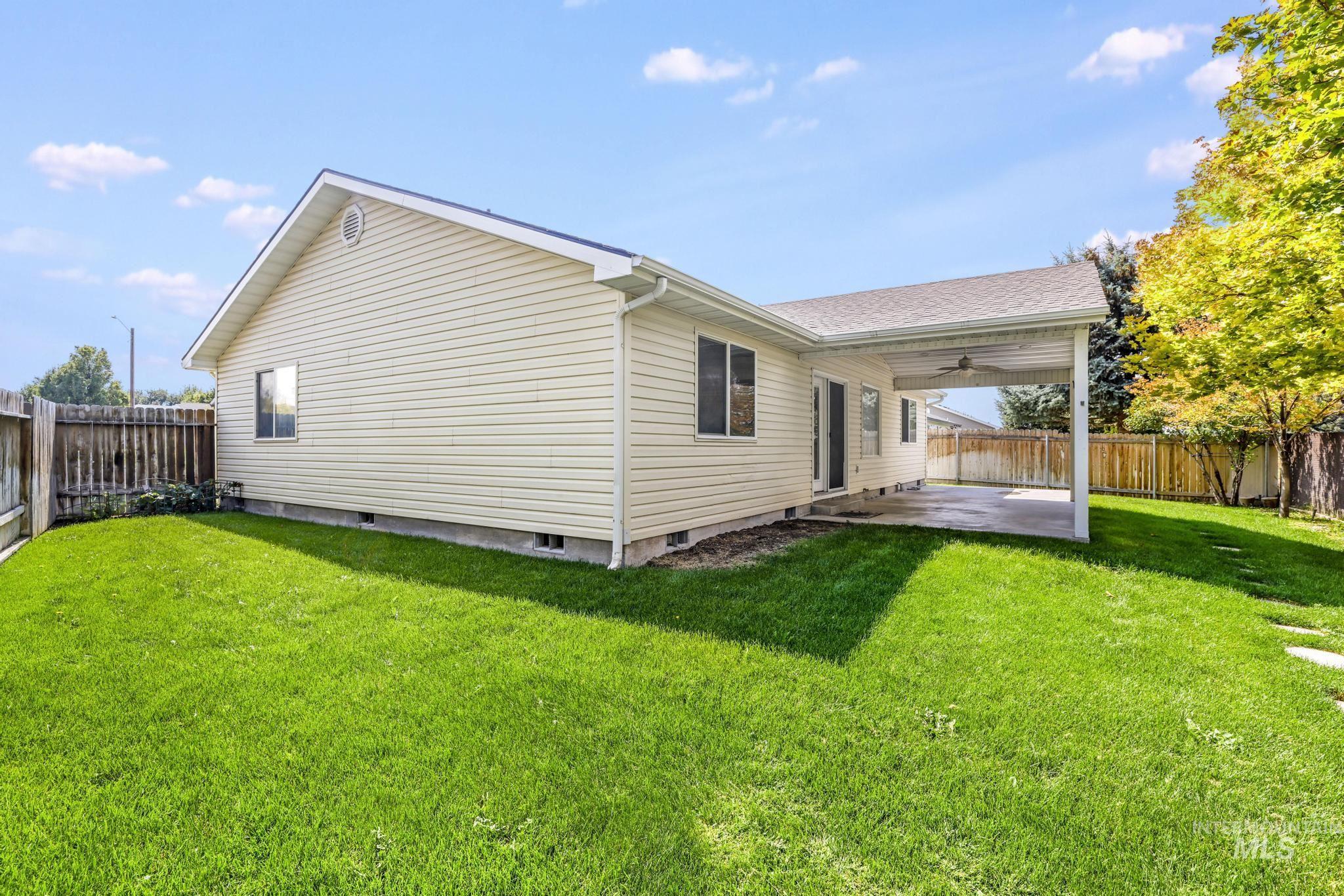 View of side of property featuring a fenced backyard, a patio area, a ceiling fan, roof with shingles, and crawl space