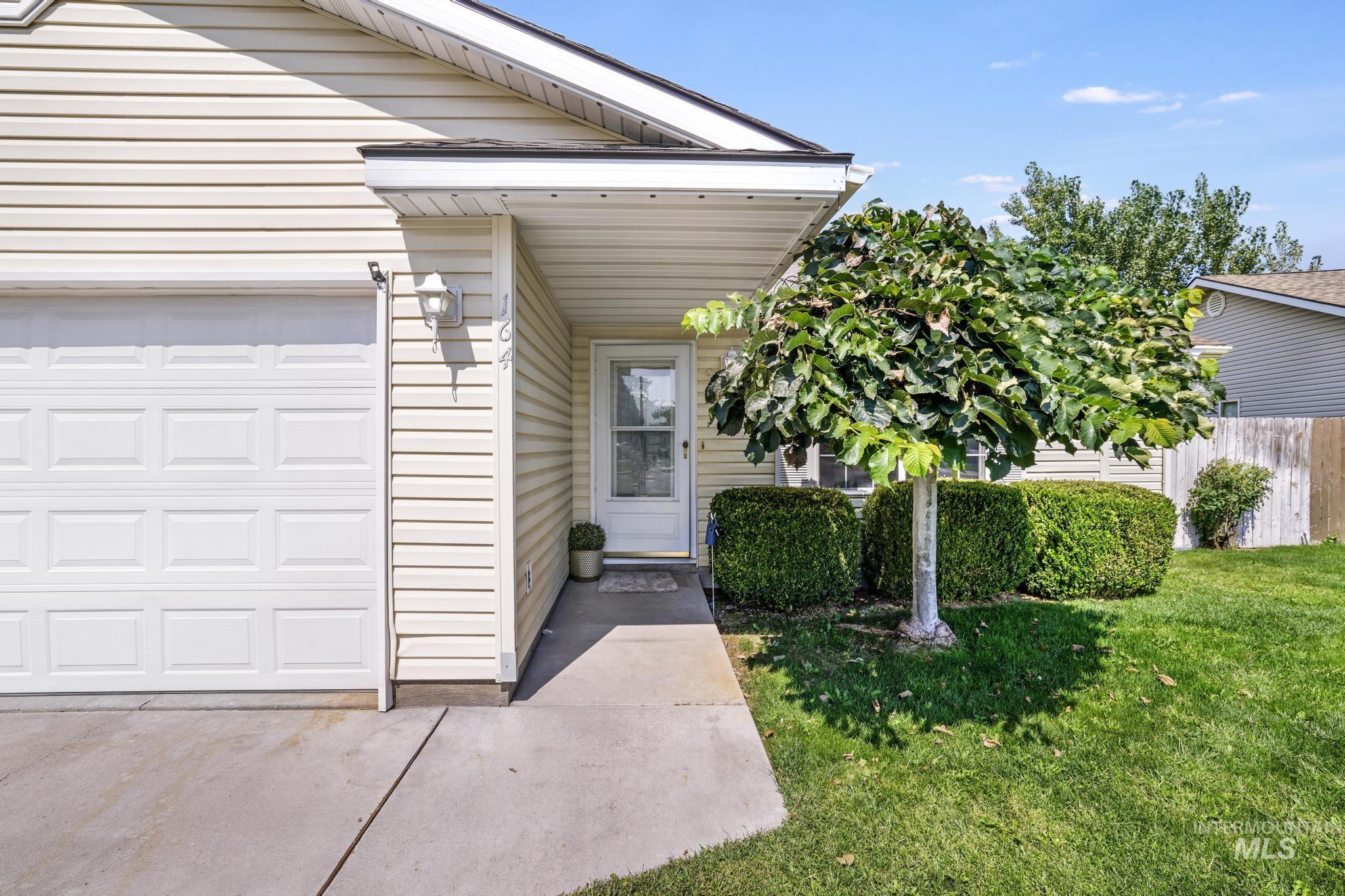 Property entrance featuring an attached garage