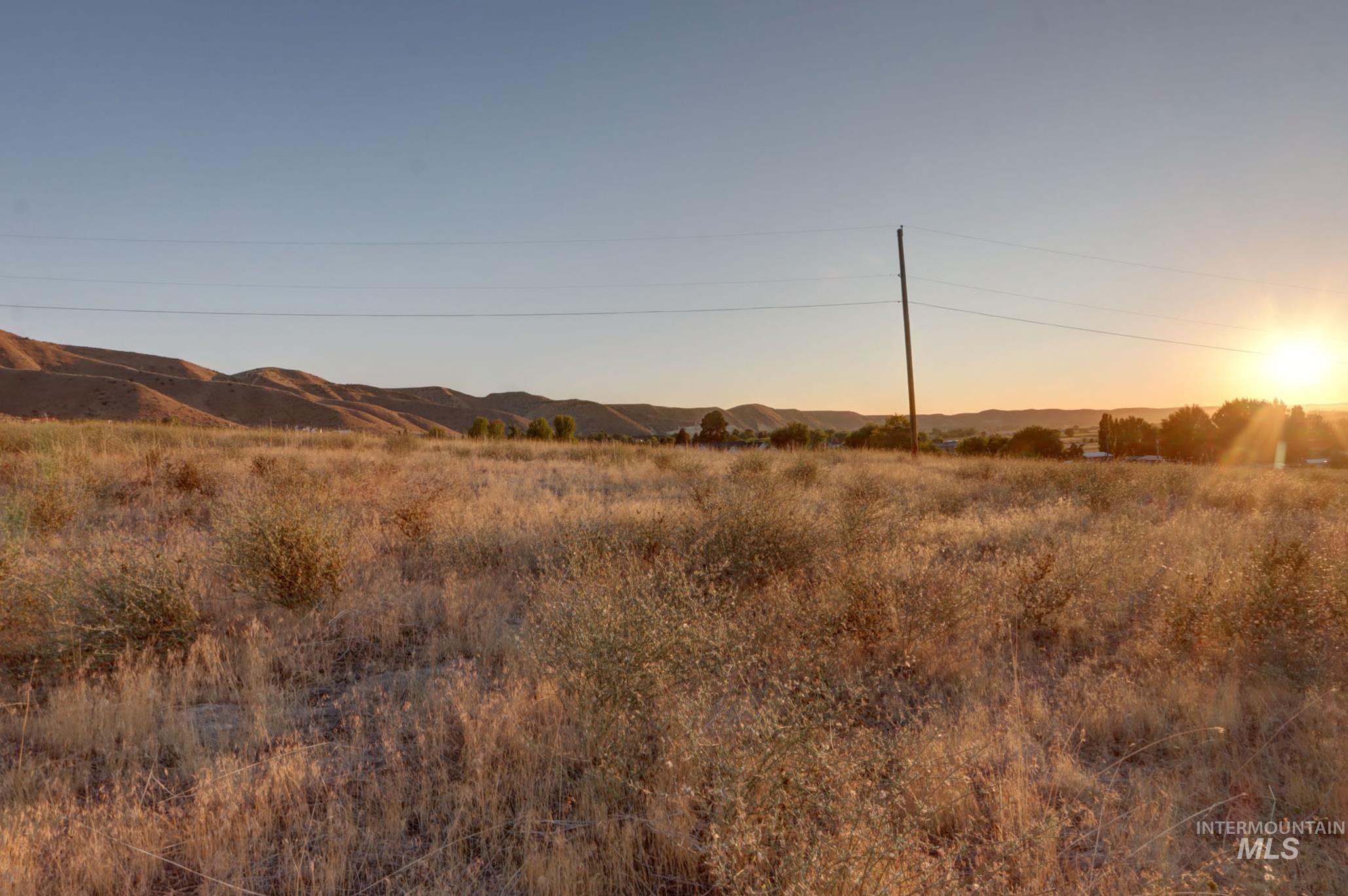 View of undeveloped land featuring mountains and rural landscape