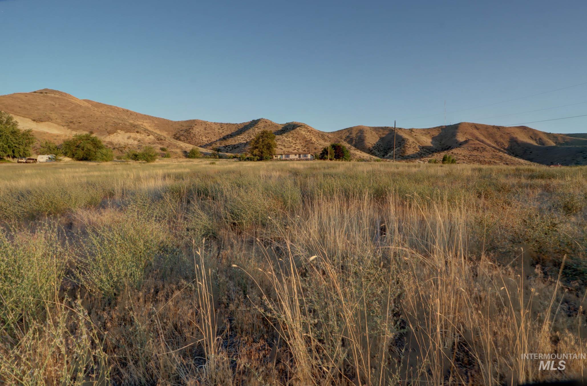 View of mountain backdrop with rural landscape