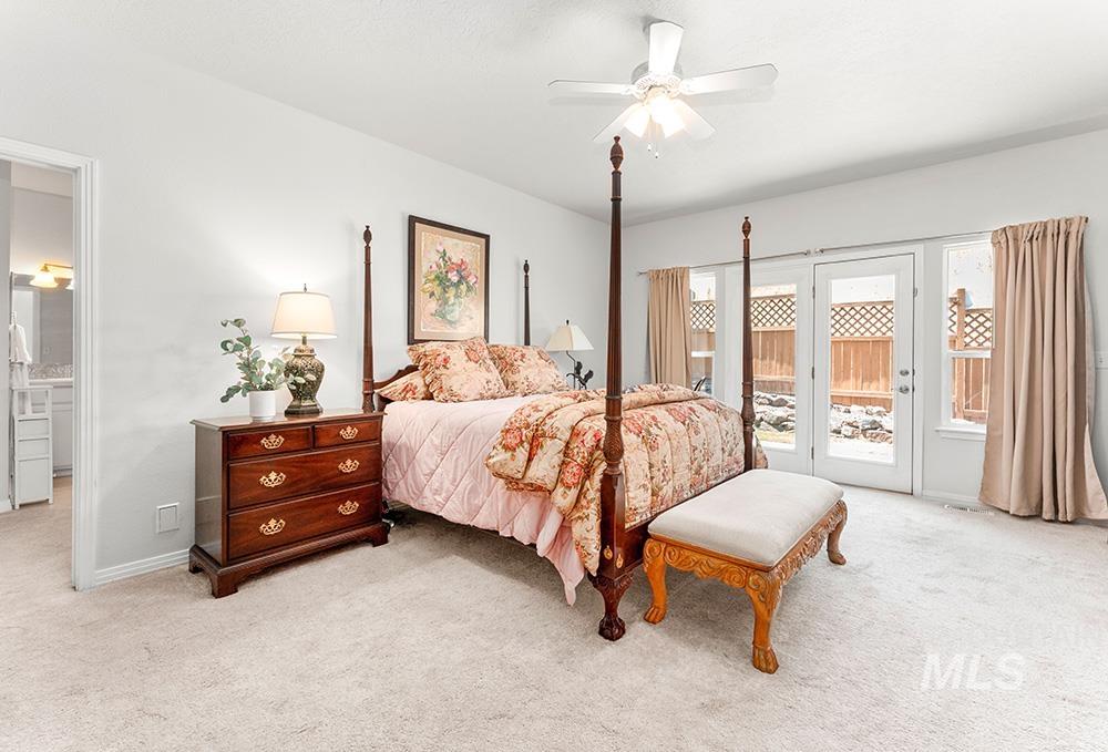 Bedroom featuring light carpet, access to exterior, and ceiling fan