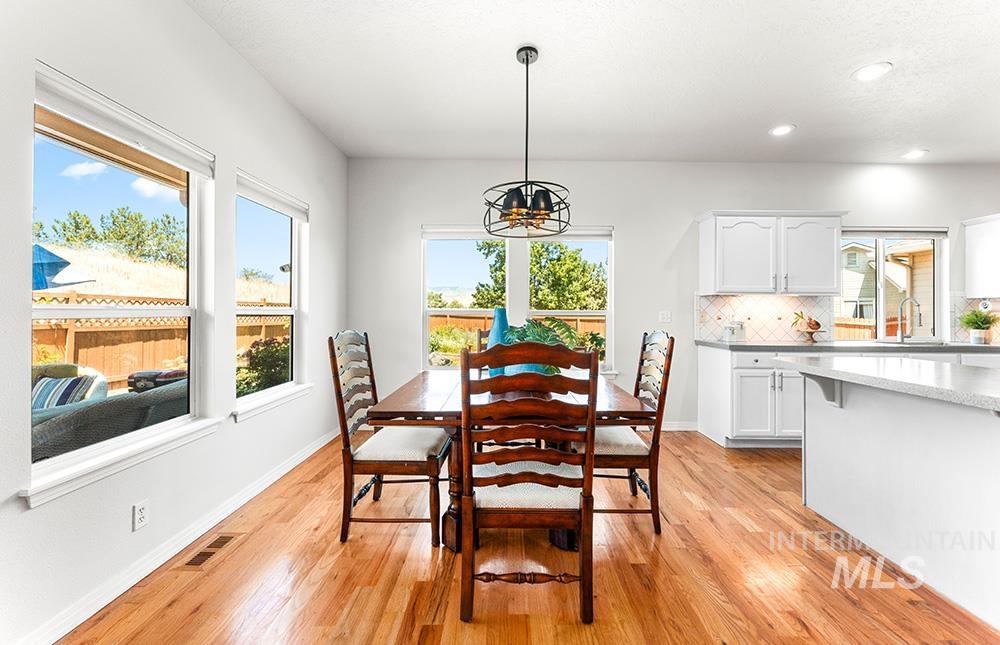 Dining space featuring light wood-style floors, a chandelier, and recessed lighting