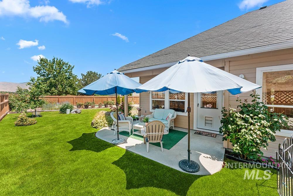 Fenced backyard featuring a patio and an outdoor living space