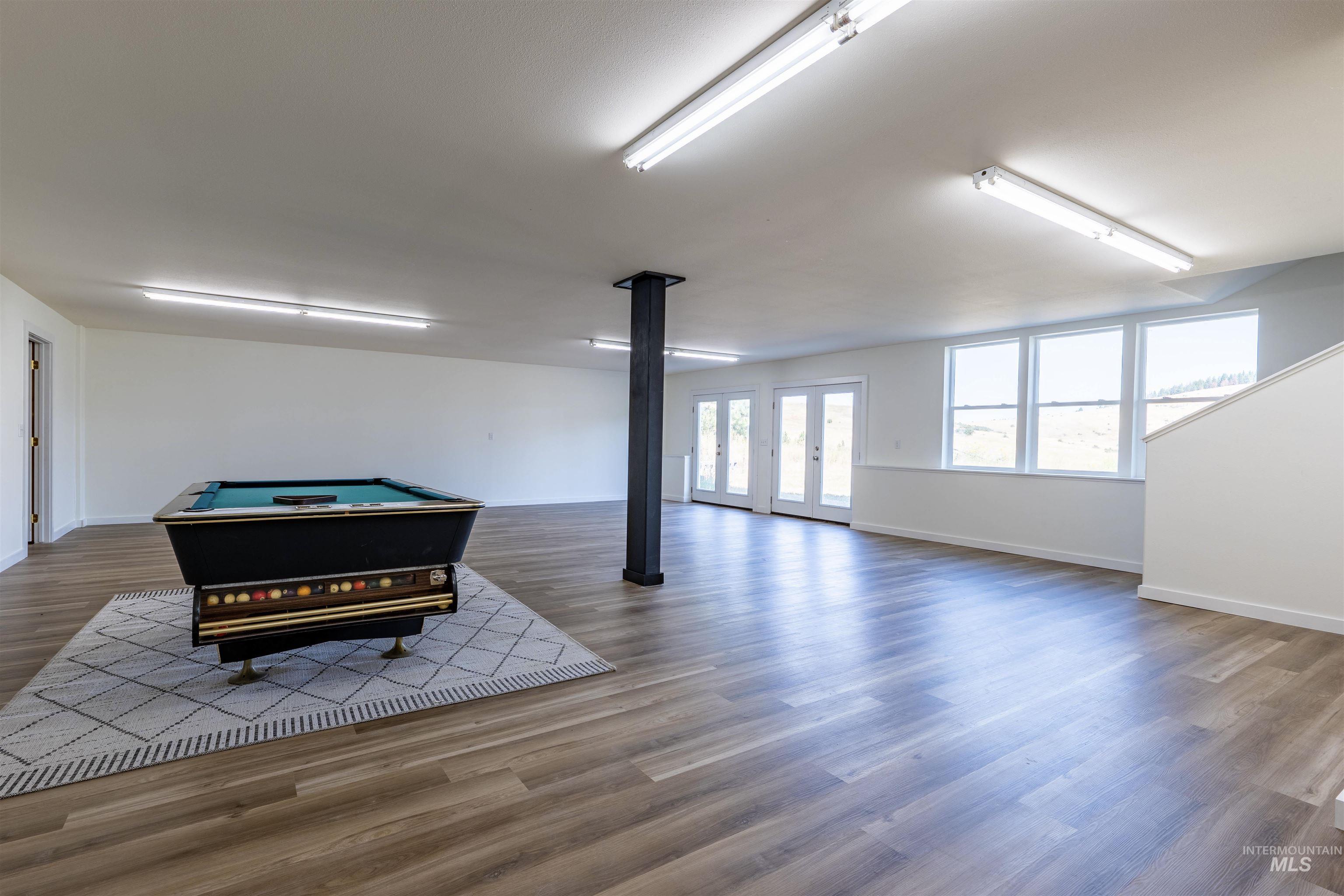 Game room featuring wood finished floors, french doors, and billiards table