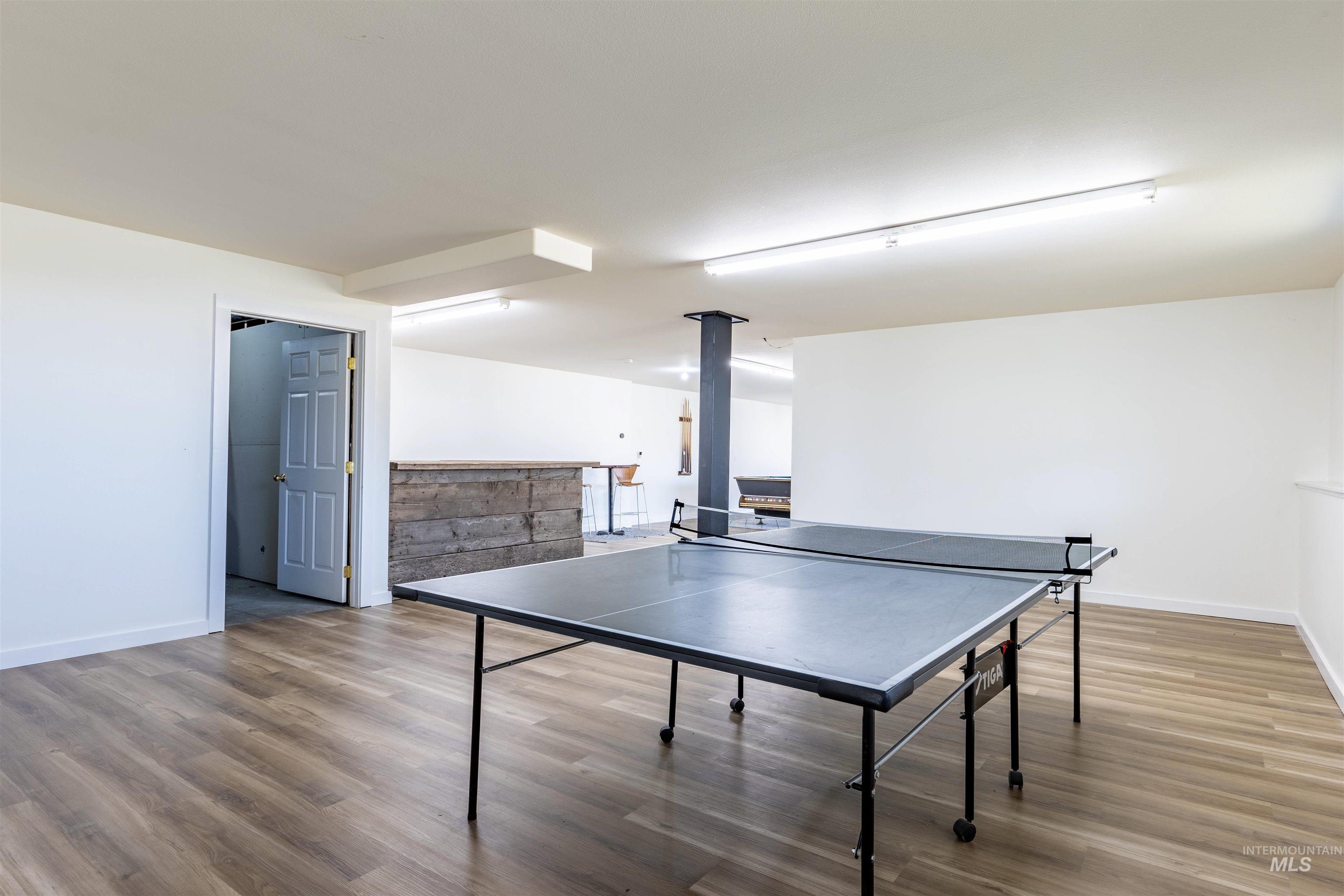 Playroom with light wood-style floors and baseboards