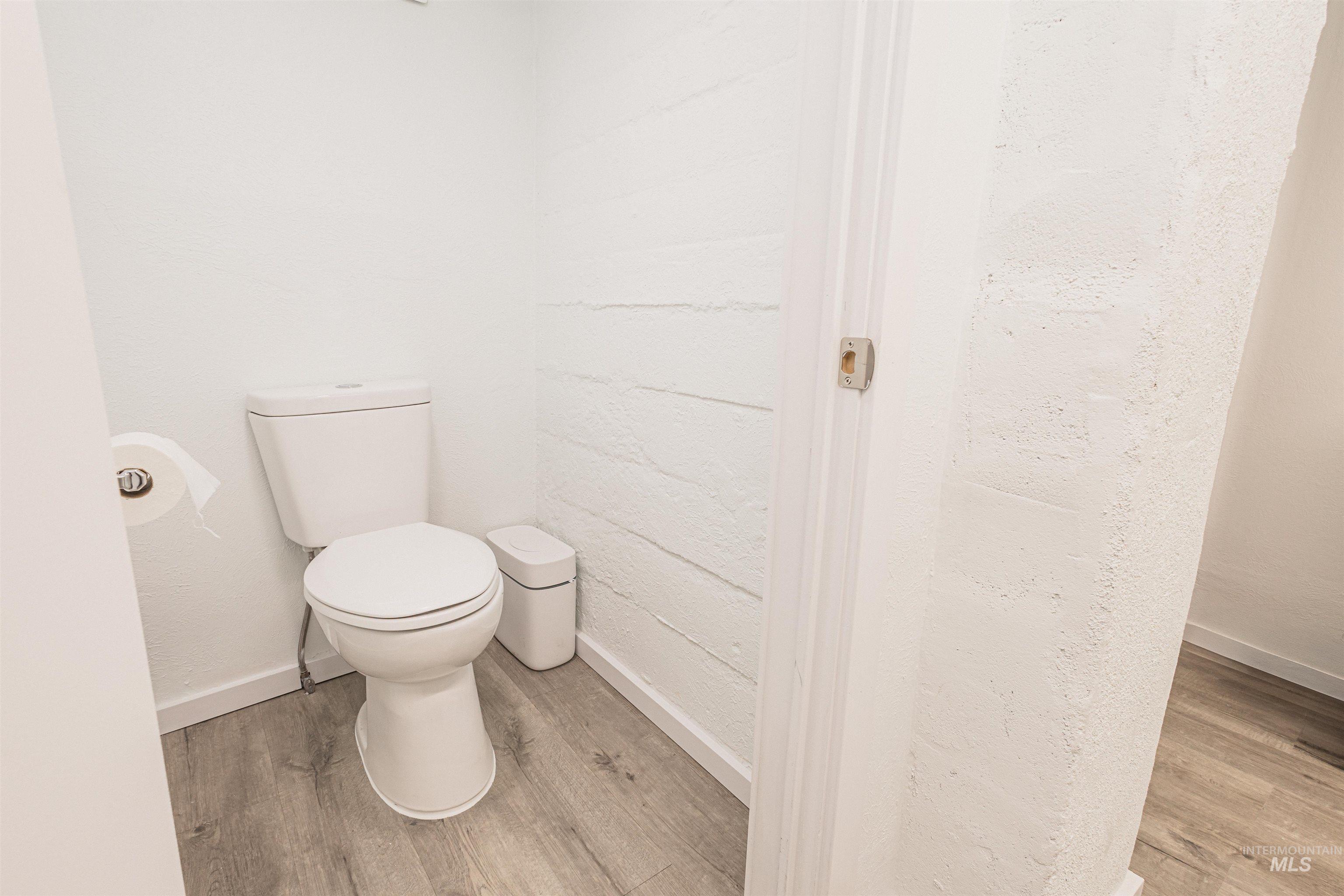 Full bathroom with vanity, tiled shower, and light wood-type flooring